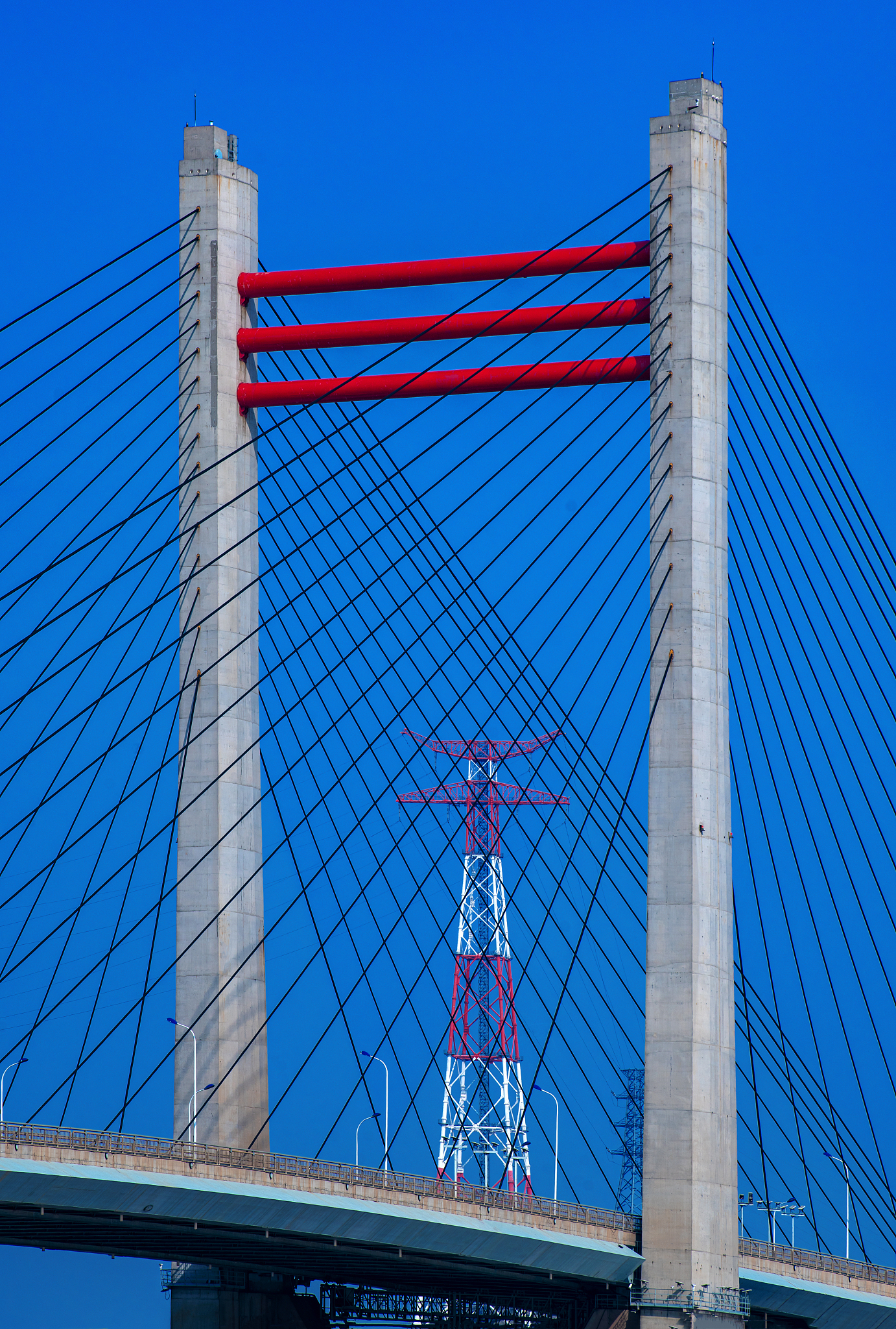 translate the following paragraph南京长江大桥是长江上首座由中国设计、采用国产材料建造的铁路、公路两用桥上层的4车道公路桥长4589米下层的双轨道铁路桥长6772米。铁路桥连接原来的天津-浦口和上海-南京两条铁路线使火车过江从过去一个半小时缩短为现在的2分钟。大桥是南北交通的重要枢纽也是南京的著名景点之一。南京长江大桥的标志着中国桥梁建设的一个飞跃大大方便了长江两岸