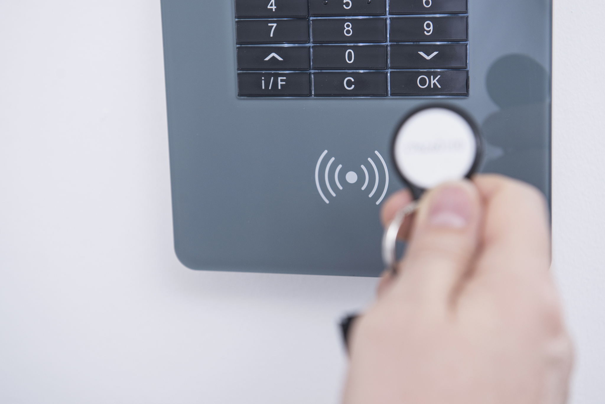 man's hand opening door protected with security system, munich, 