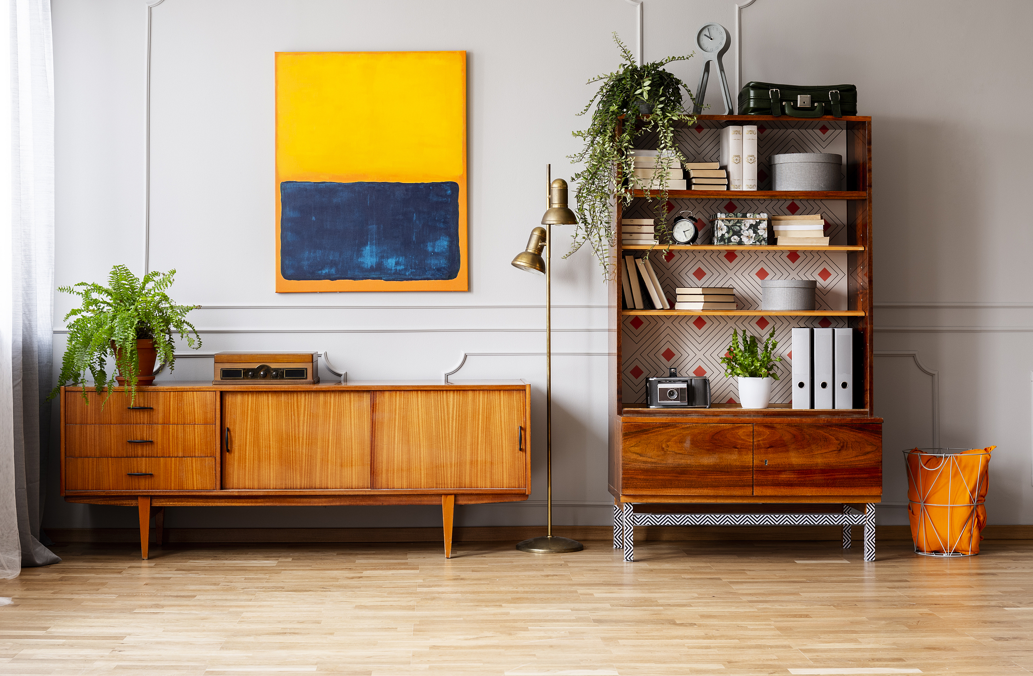 golden lamp between bookshelf and cabinet in stylish retro desig