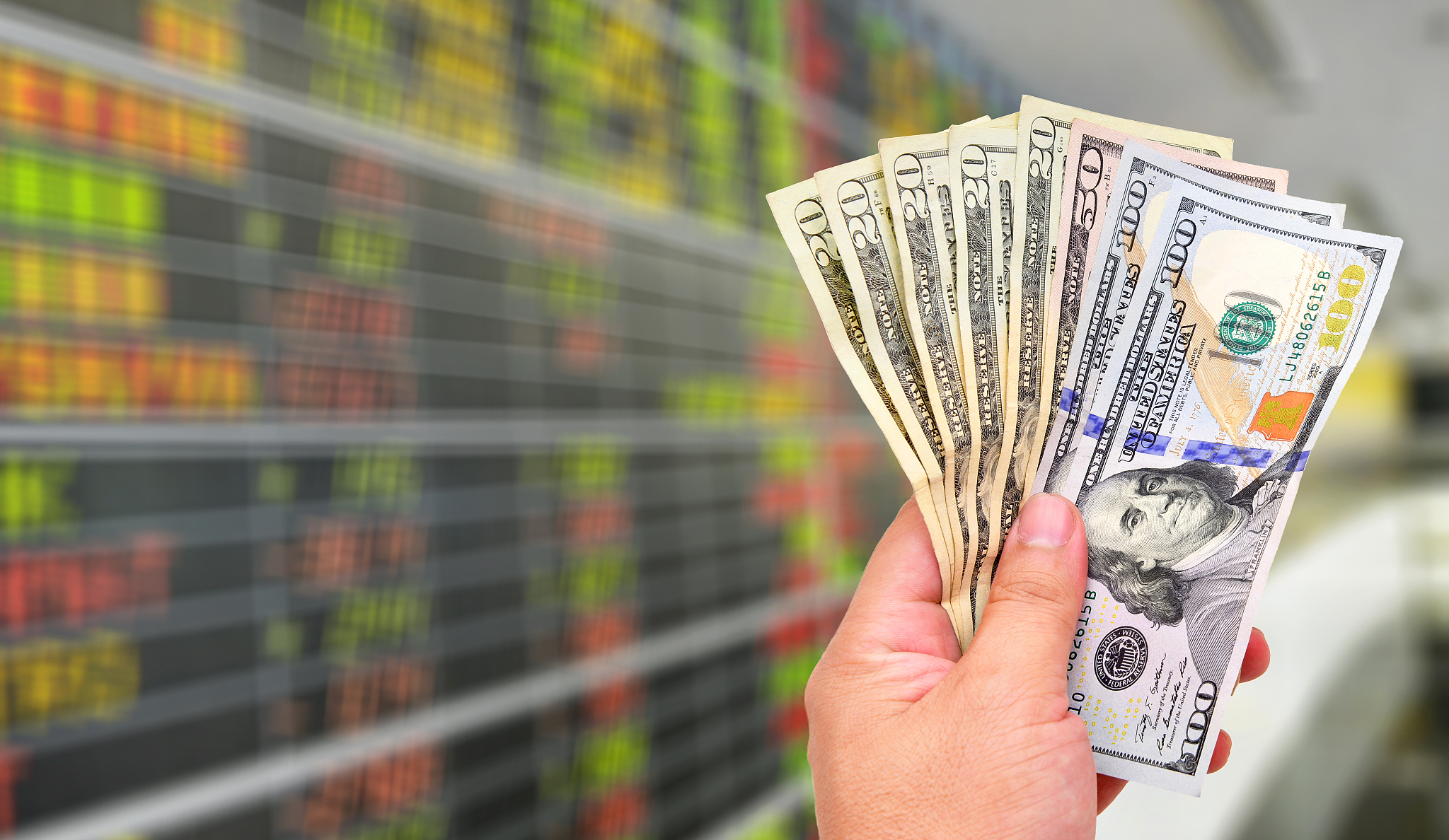 dollar banknotes on stock market background.