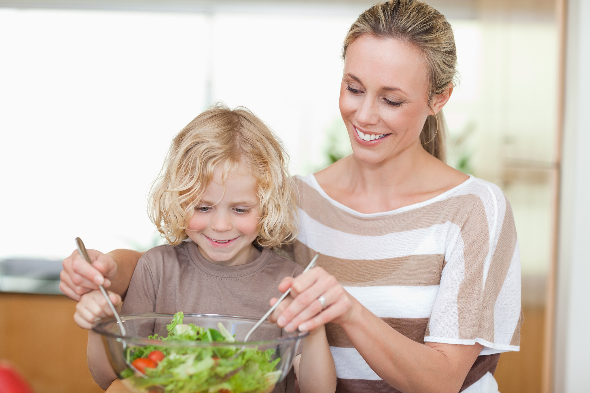mother and son preparing salad together
