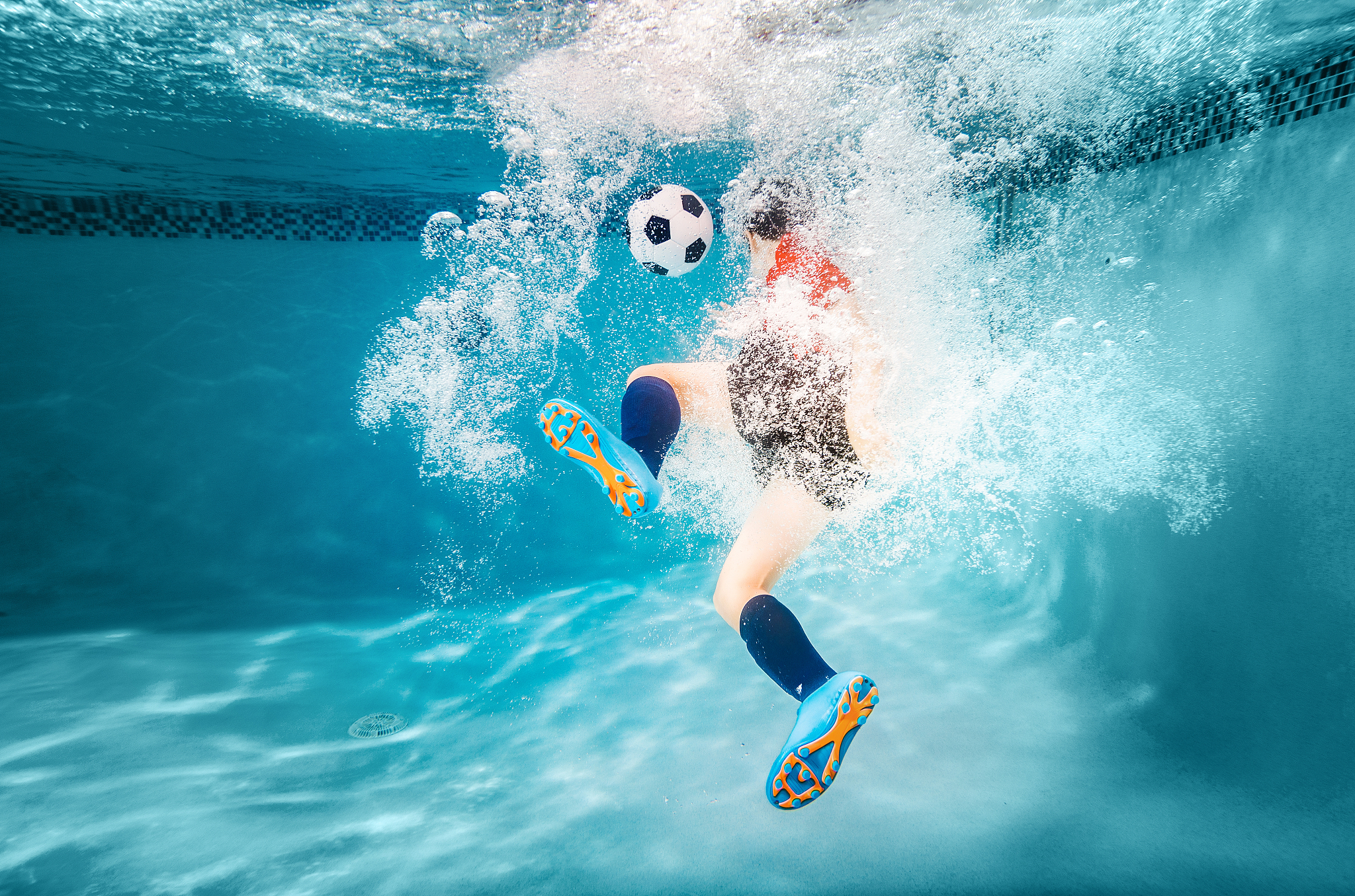 kid underwater soccer