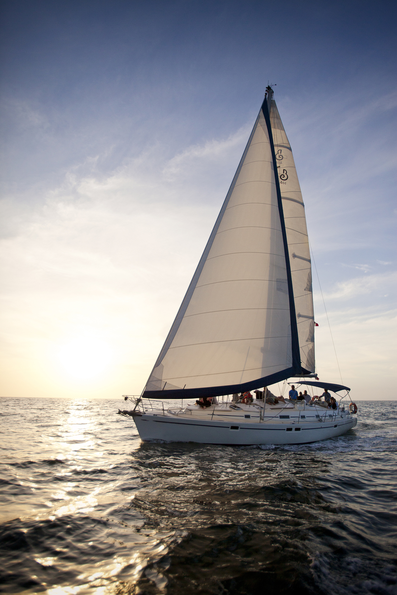 sail boat sailing in the setting sun