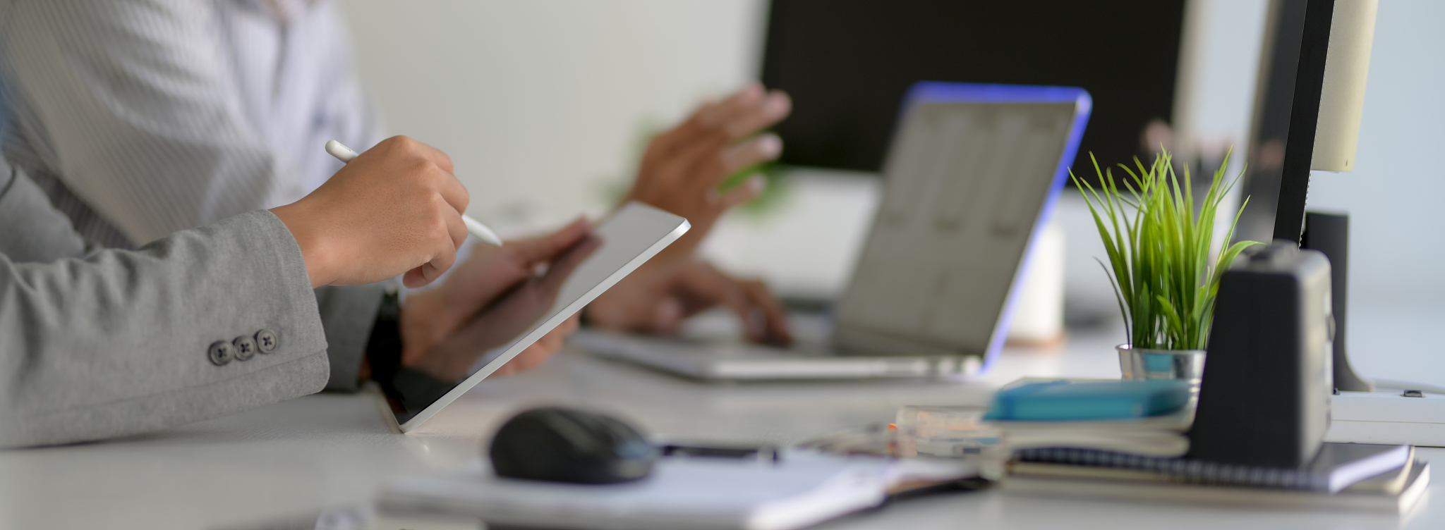 side view of businesspeople working together with tablet, laptop