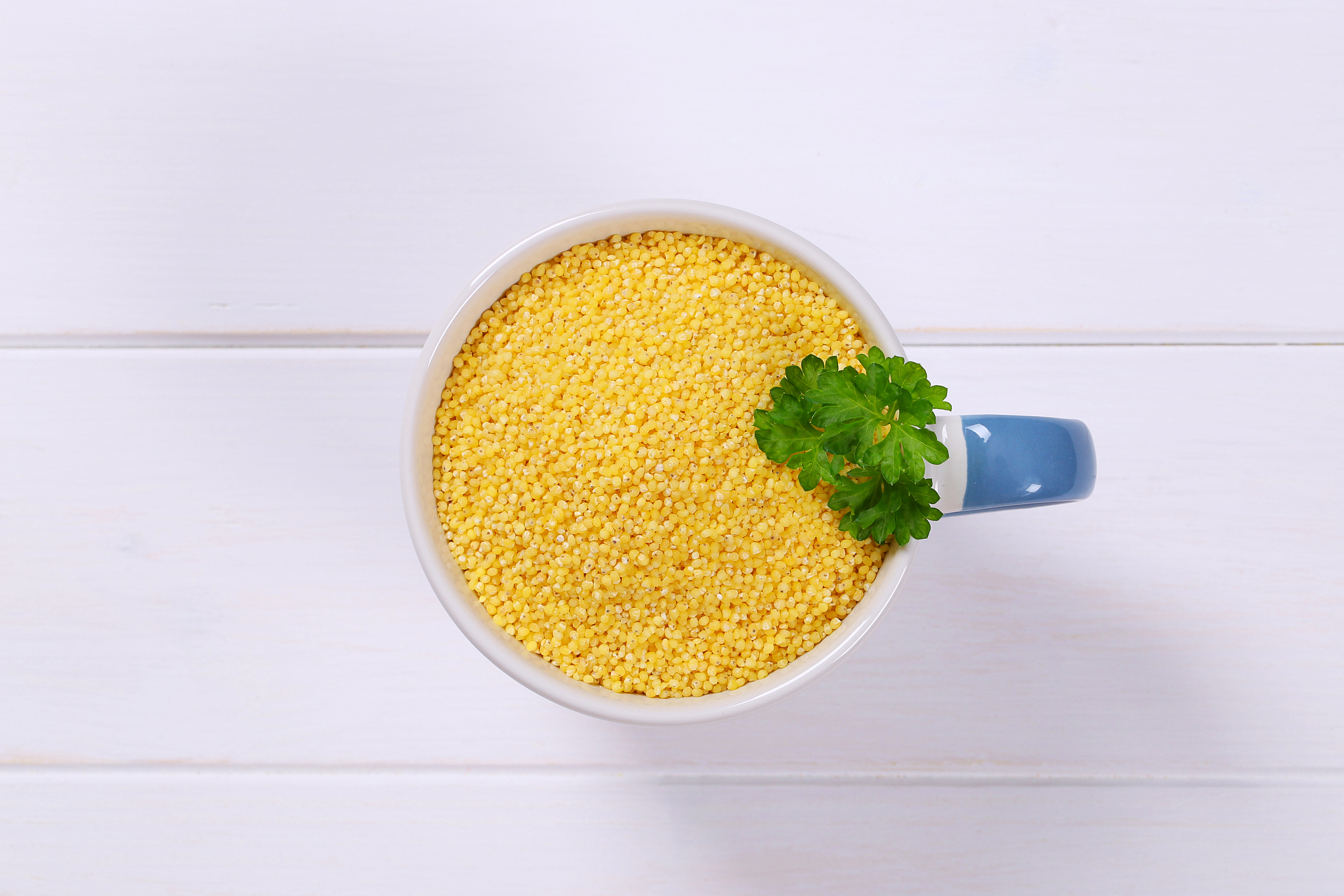 mug of raw millet grains