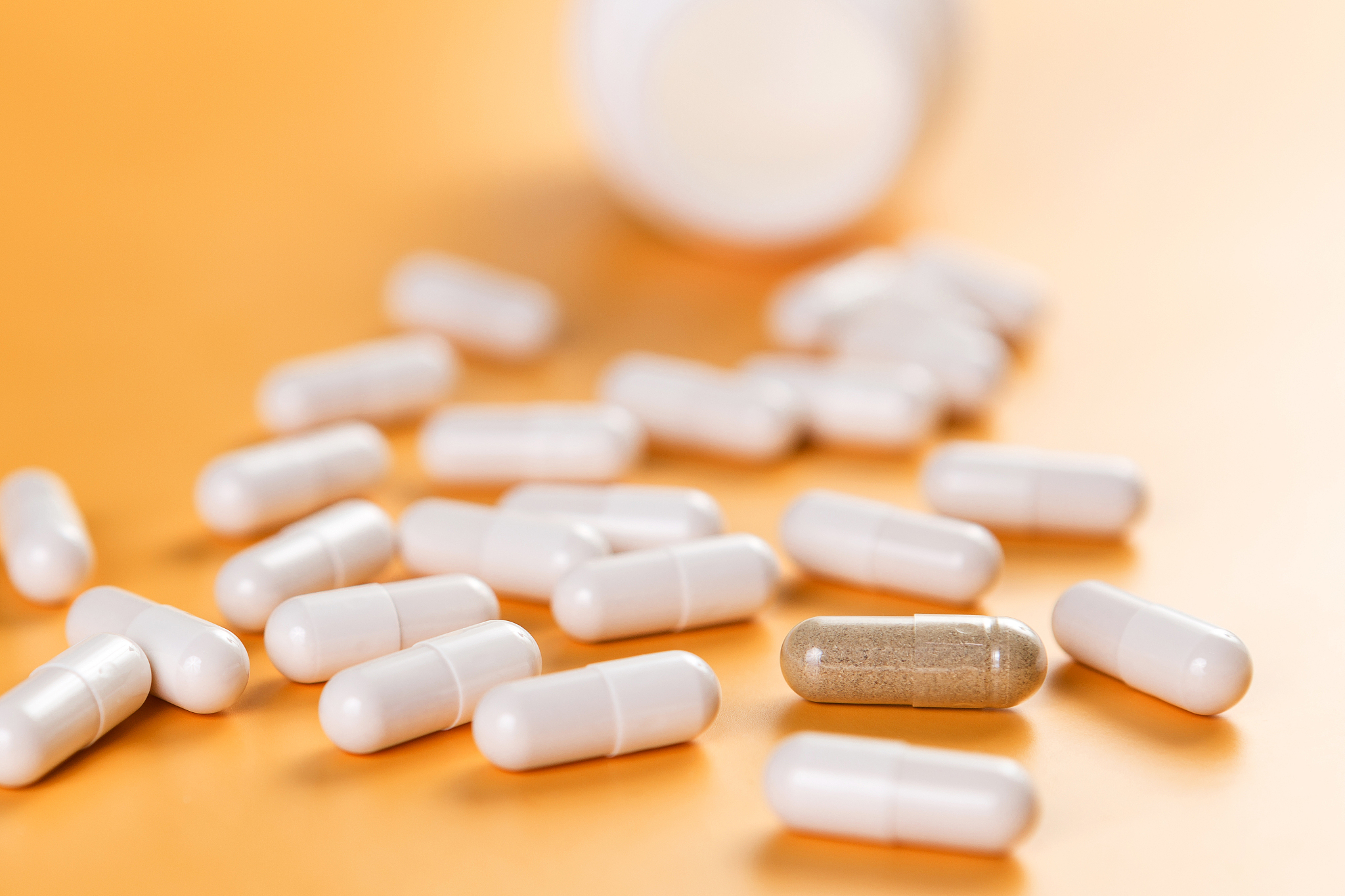 pharmaceutical medicine white capsules whith one brown capsule o