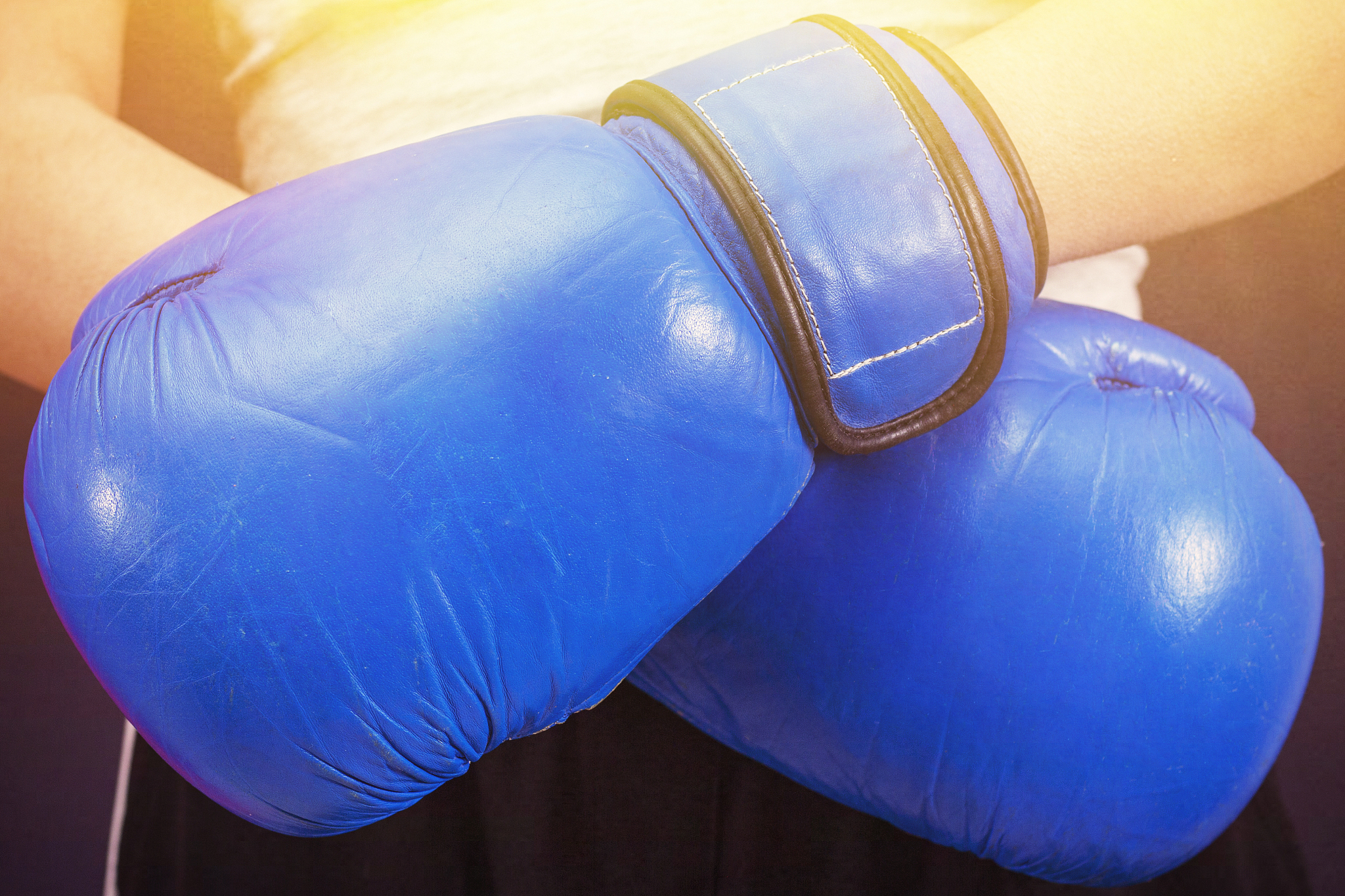 blue boxing gloves on the hands of a girl