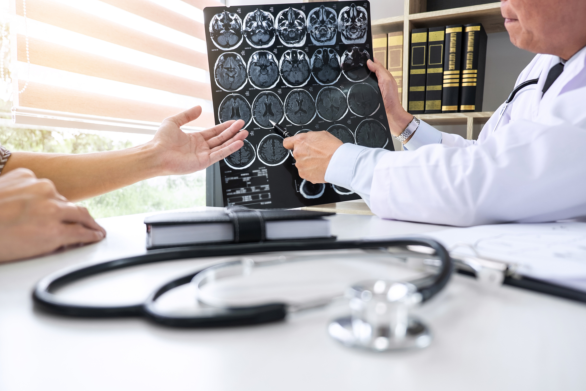 professor doctor having conversation with patient and holding x-