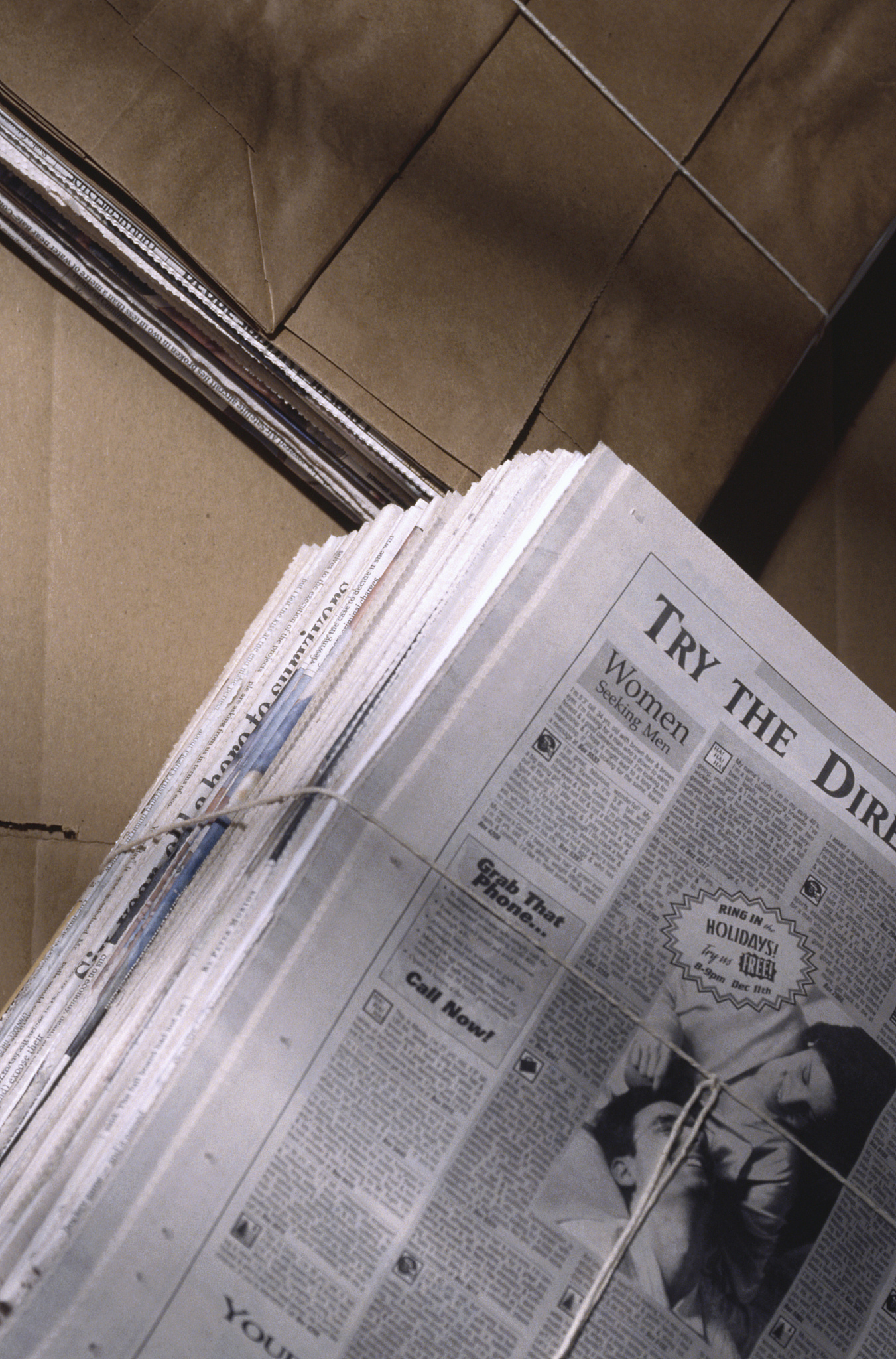 bundle of newspapers with cardboard for recycling