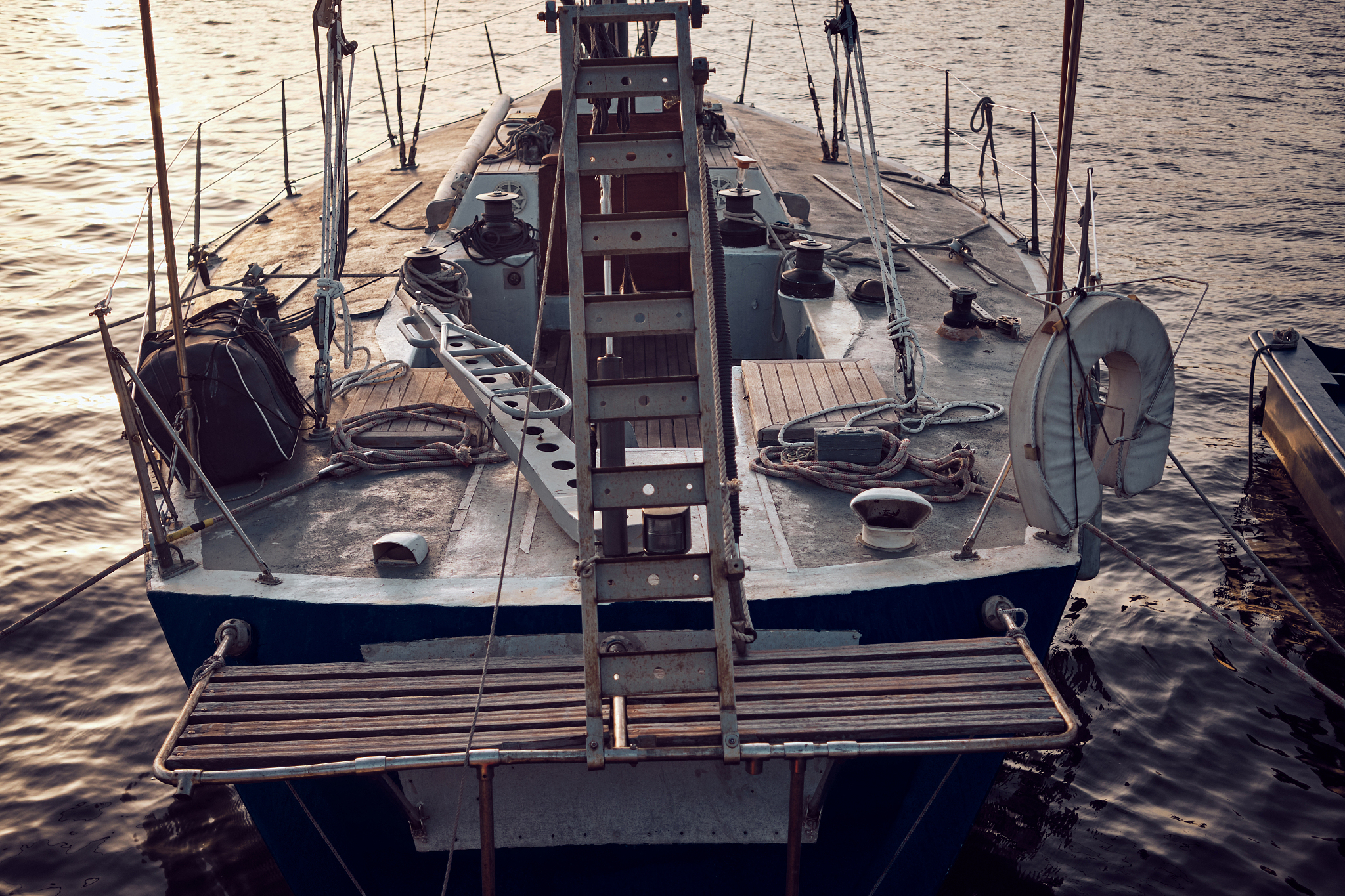 old sail boat in the port at sunset.