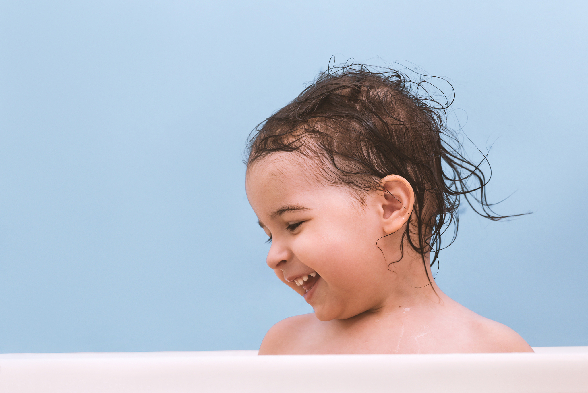 cheerful happy toddler baby taking a bath playing with foam . li