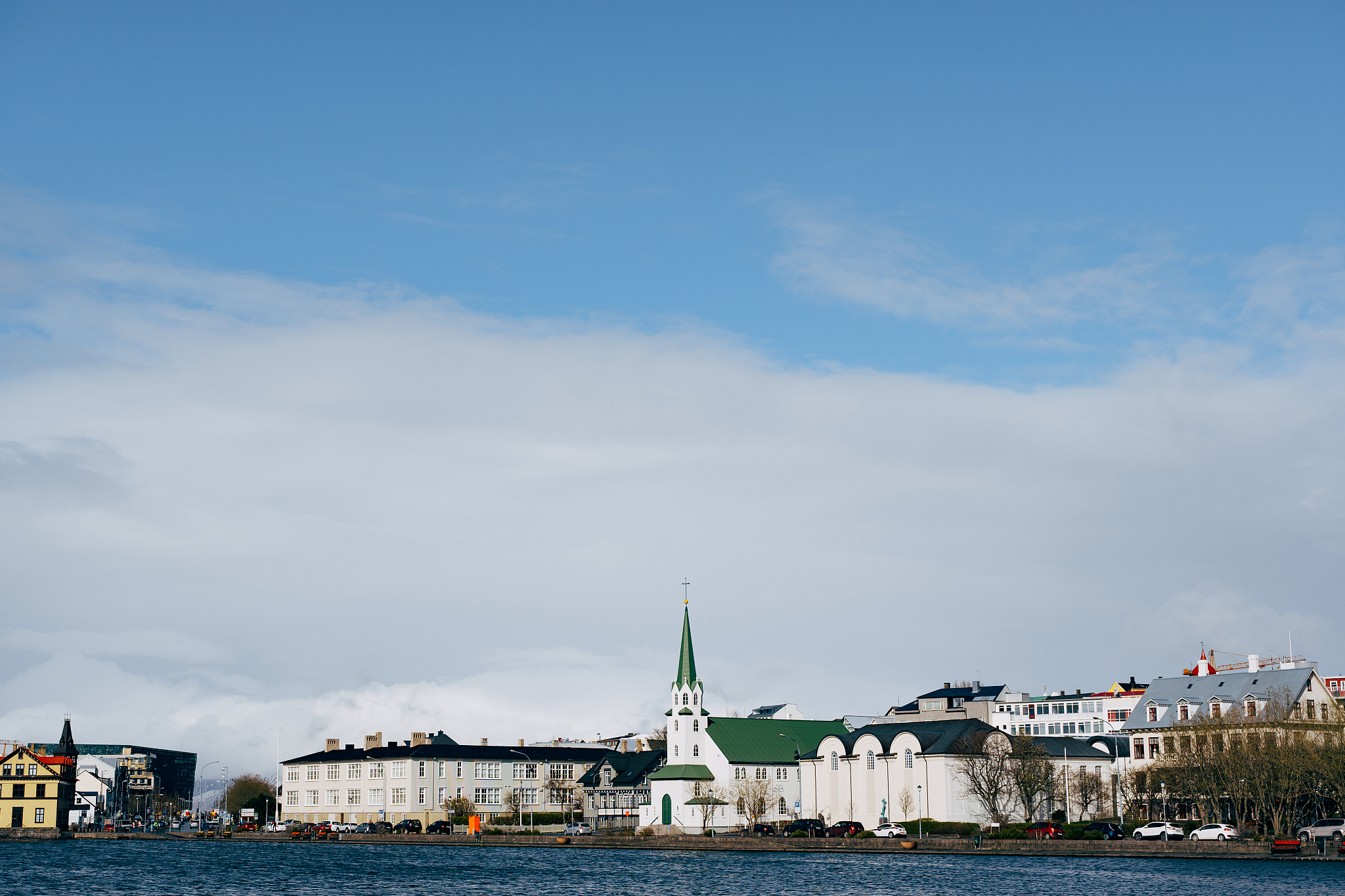 buildings on the shore of lake tjodnin, in reykjavik, the capita