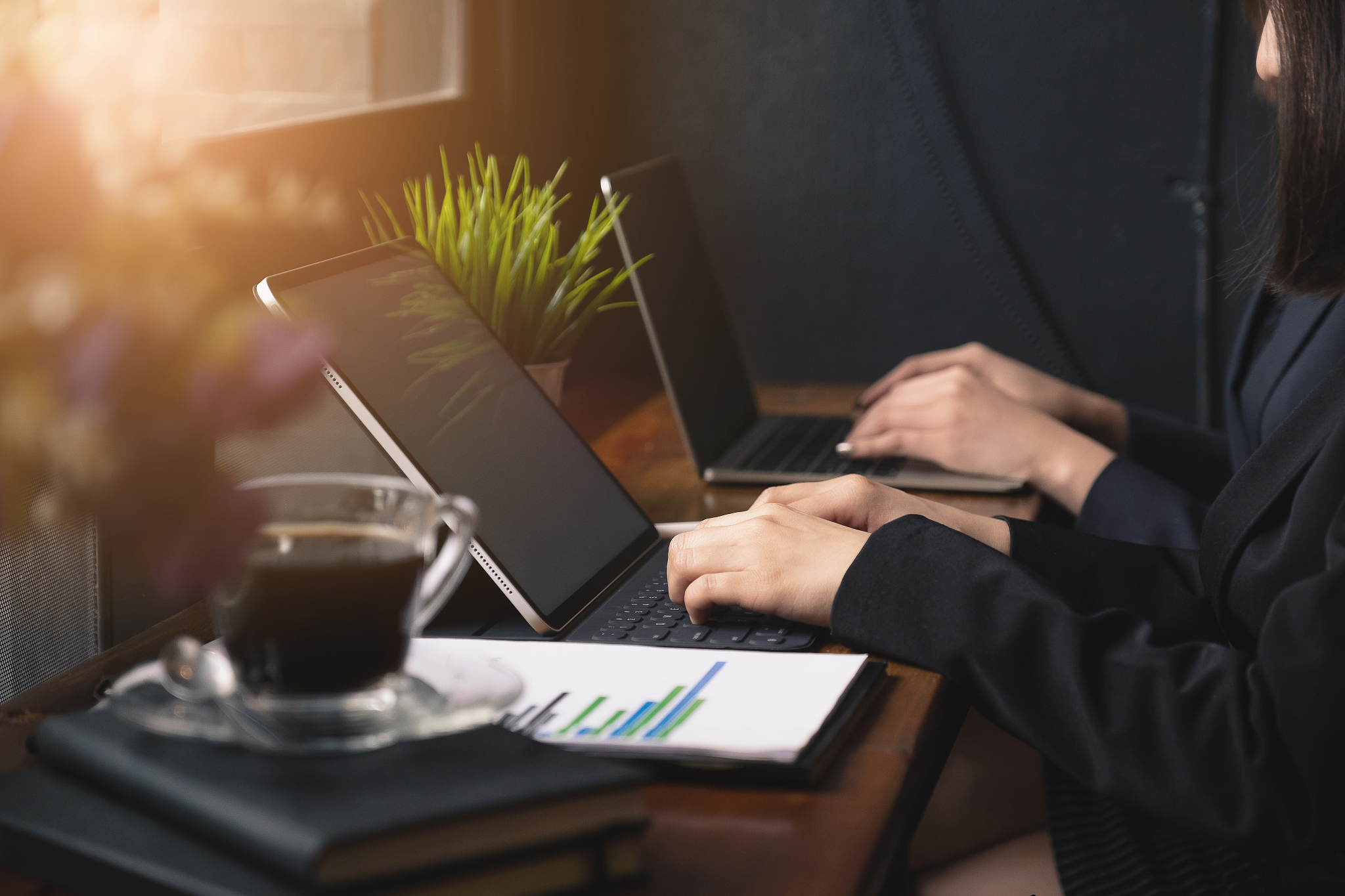 two businesswoman working and communicating while sitting at the