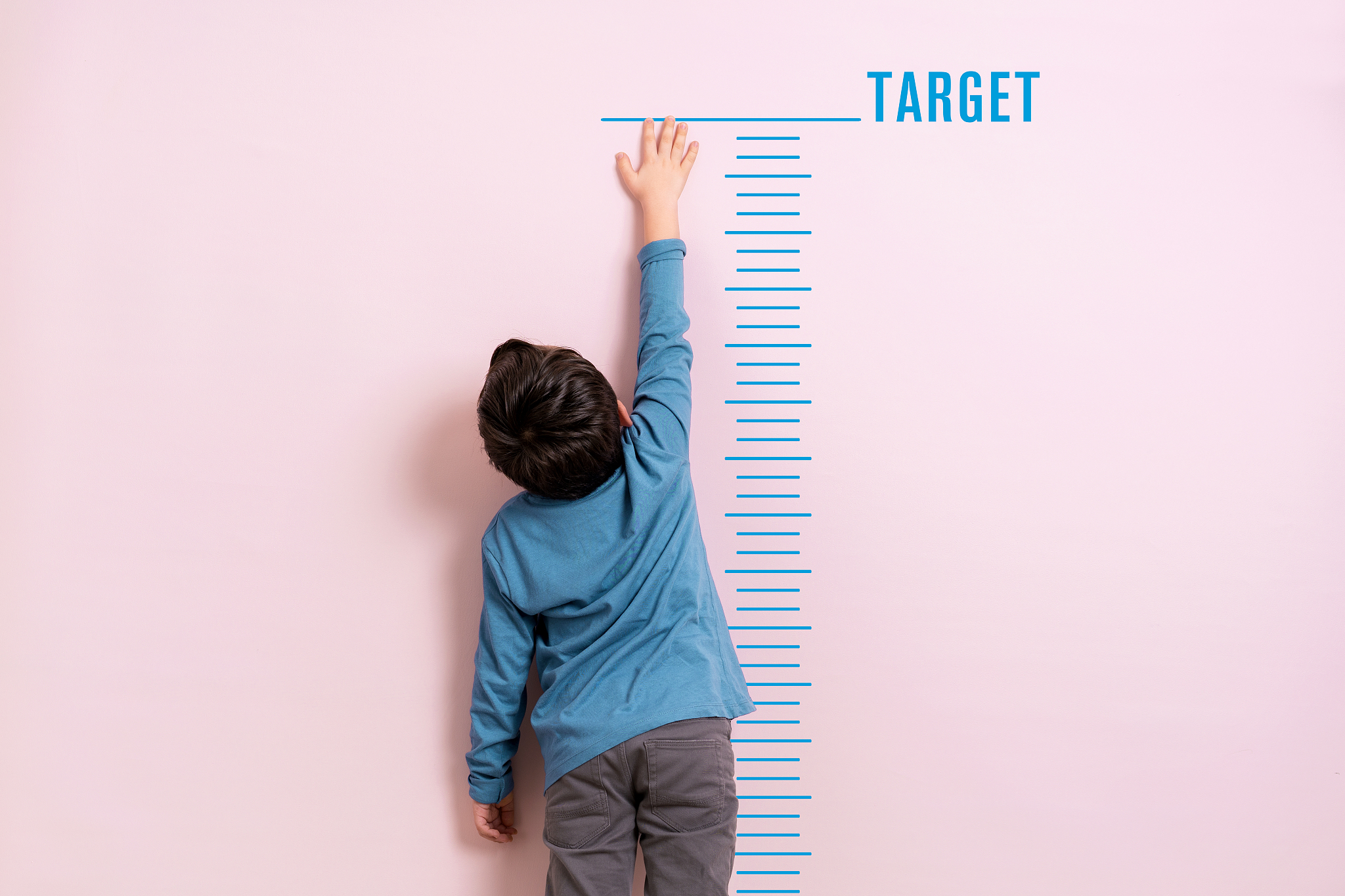 child measuring his height