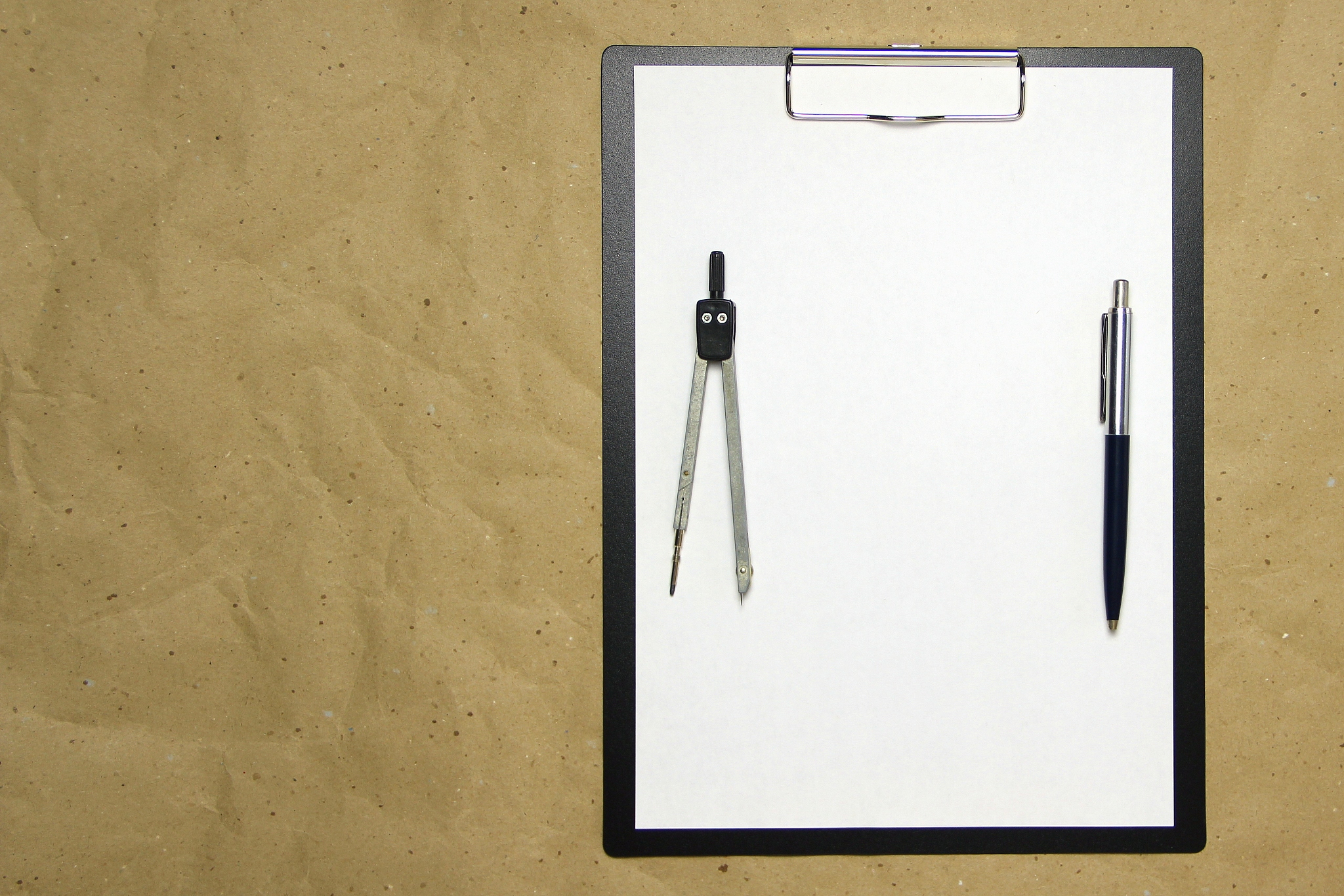 a tablet with a white sheet of a4 format on a beige craft paper