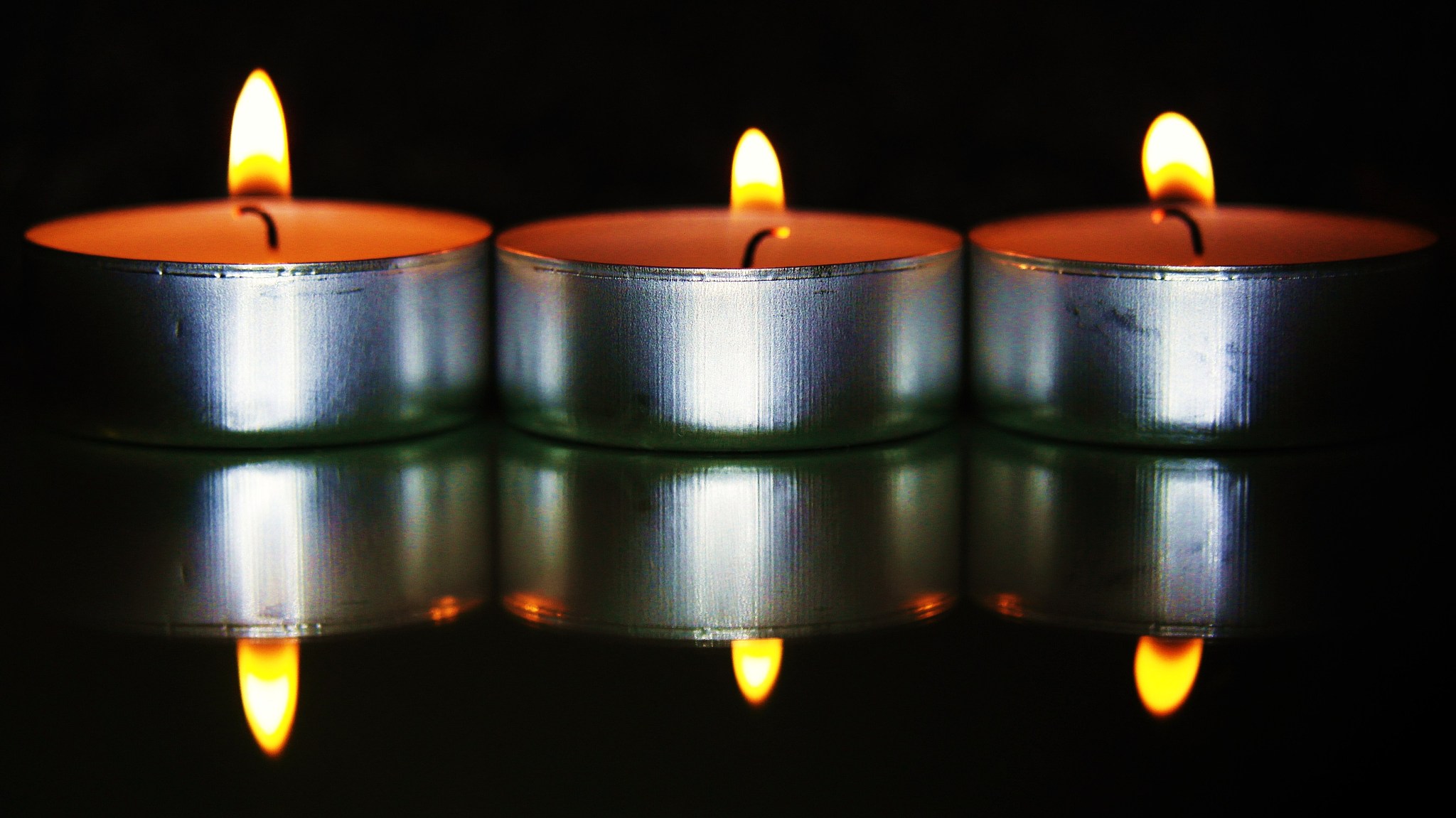 three candles on glass