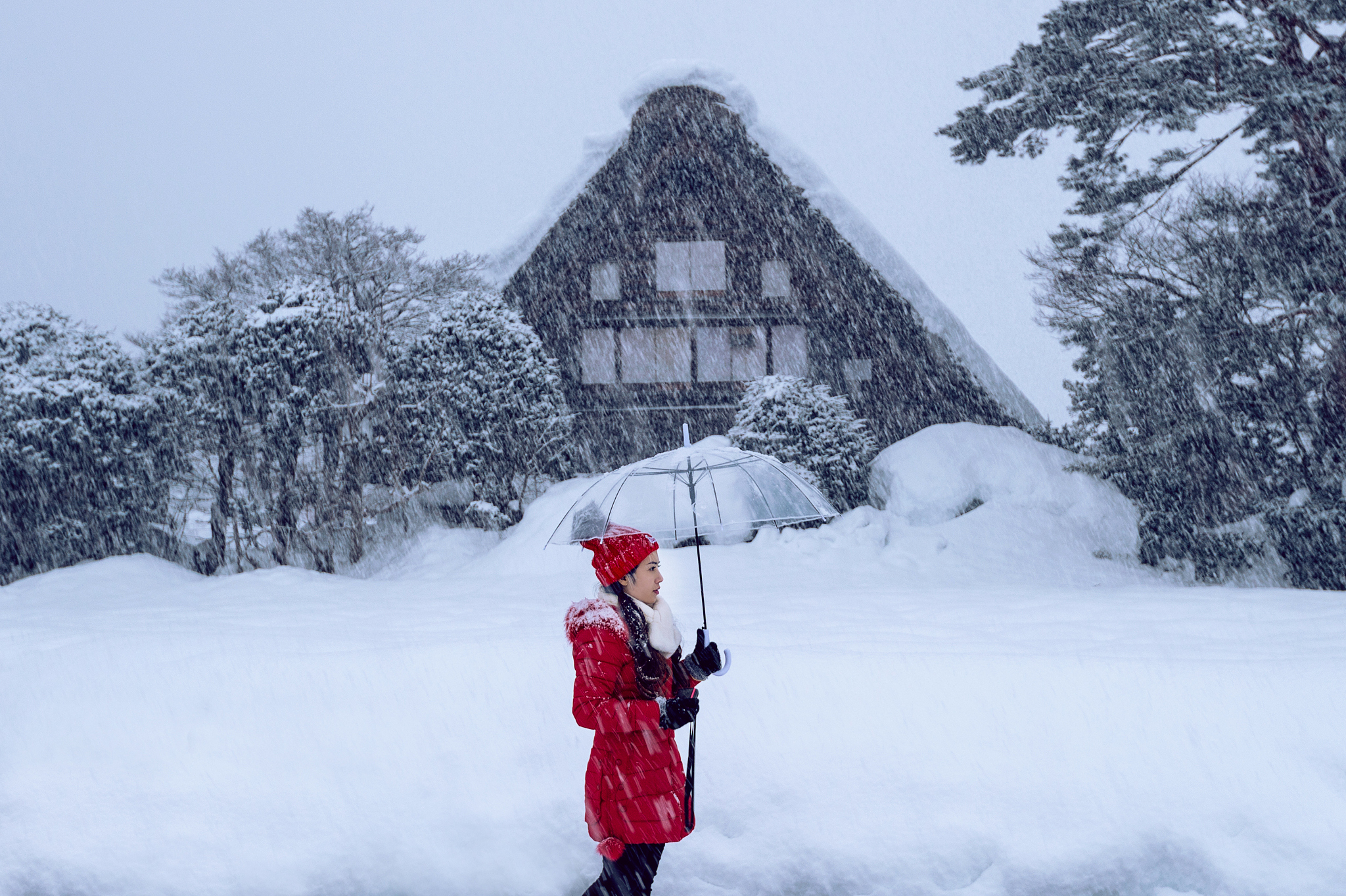 young woman in shirakawa-go village in winter, unesco world heri