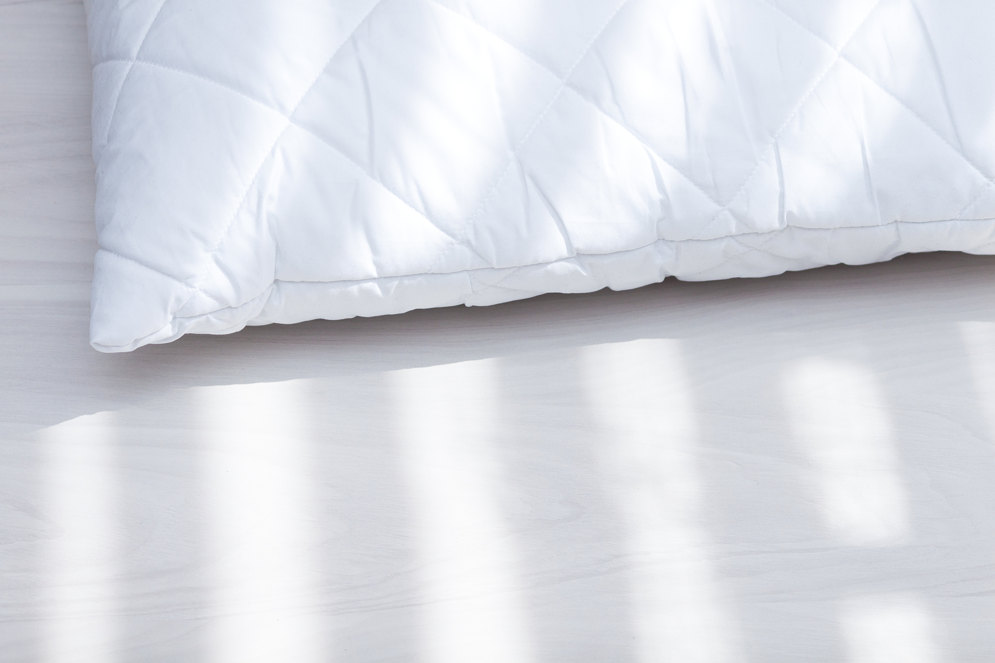 white hypoallergenic pillow in sunny day, sunlight. allergy dust