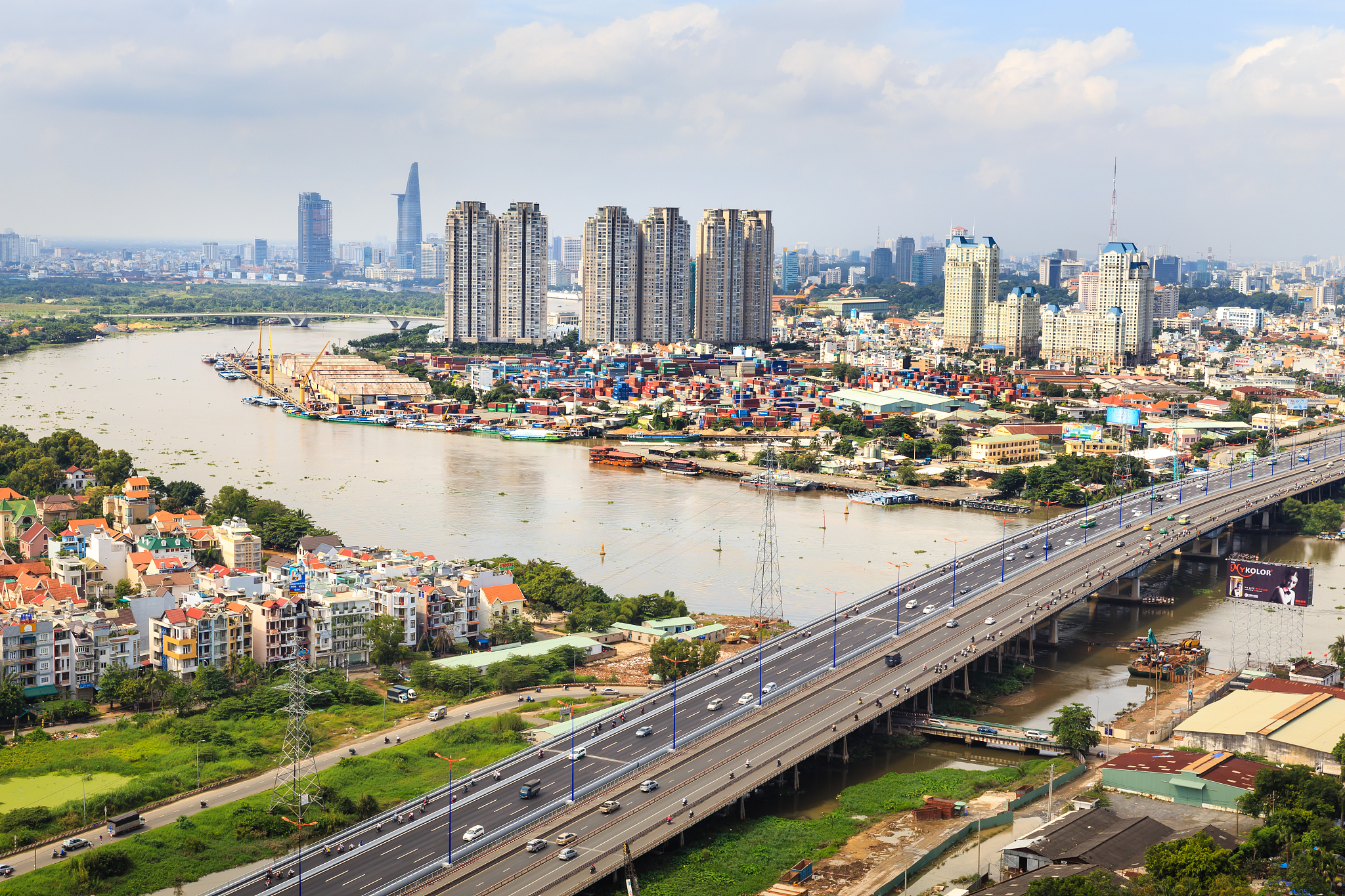 high angle view of bridge and buildings in city against cloudy s