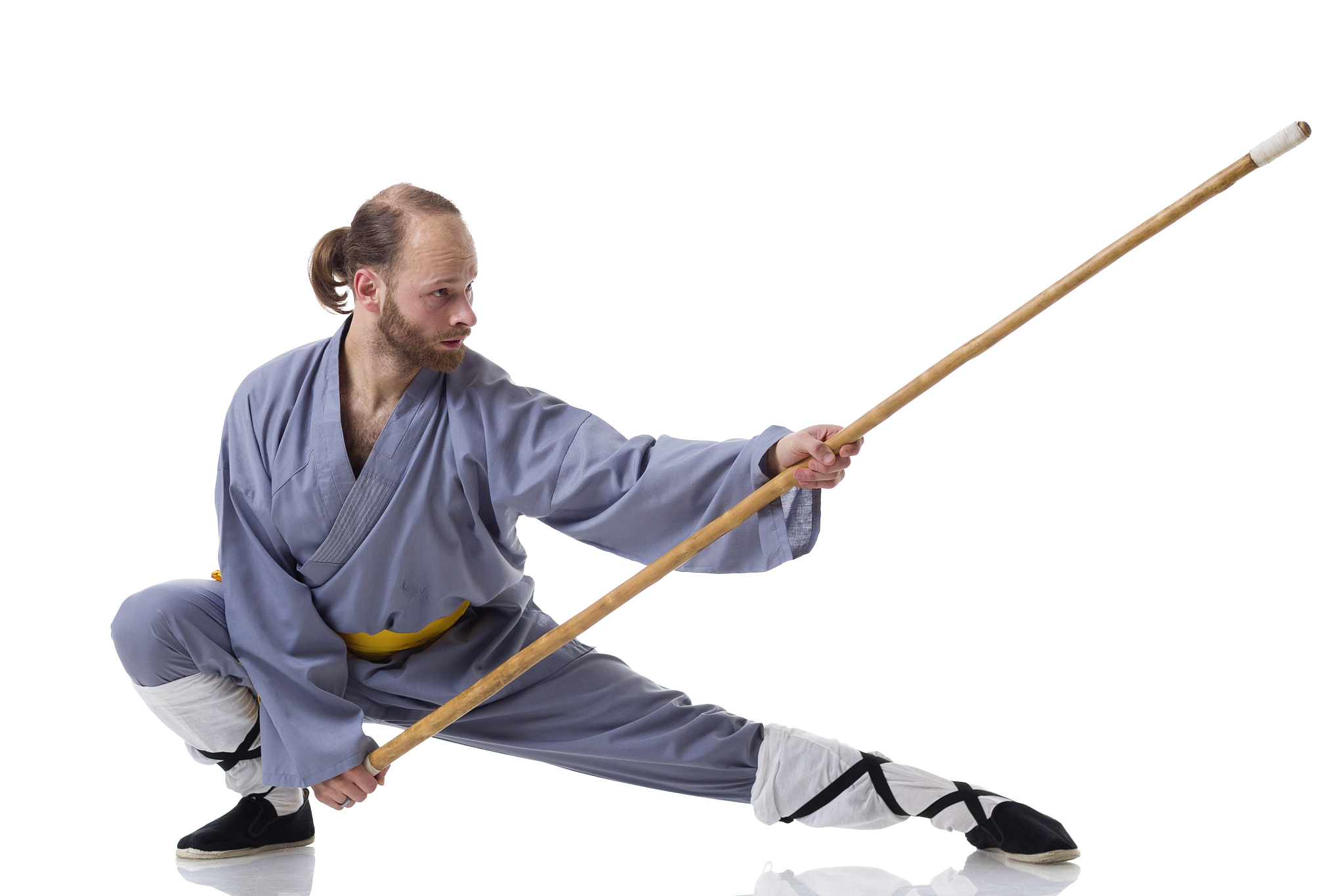 kung fu fighting position with wushu cudgel isolated on white