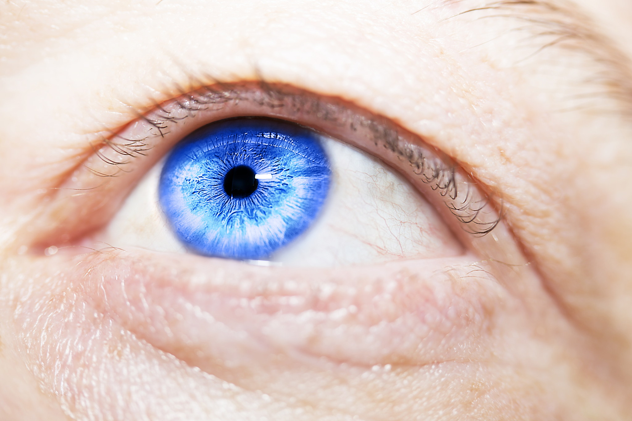 image of man's blue eye close up.