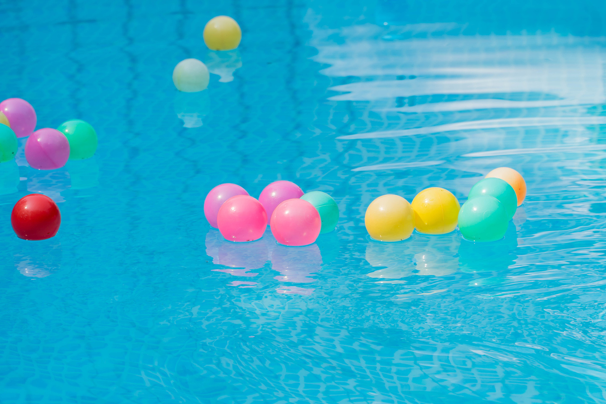 colorful plastic balls in swimming pool.