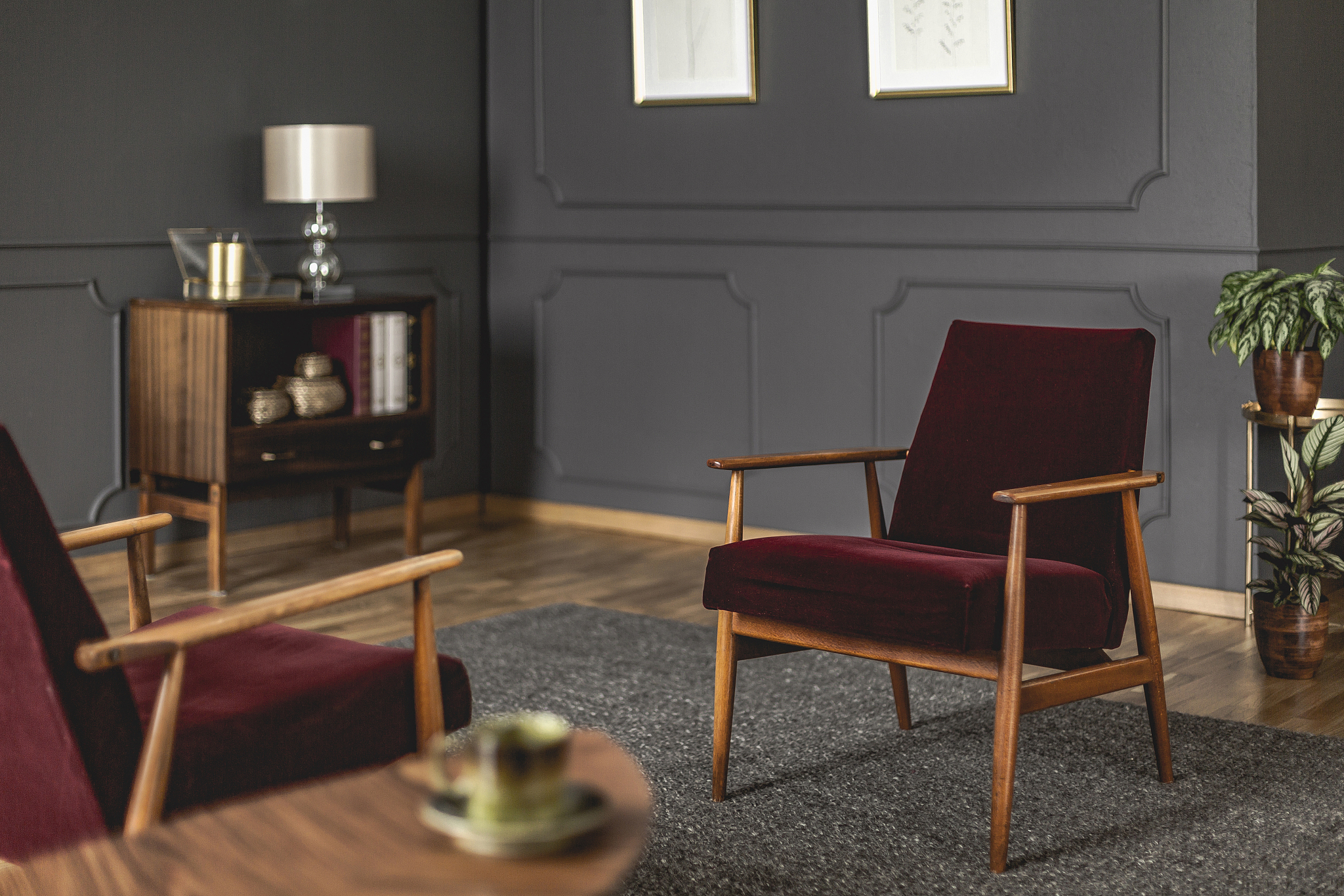 burgundy armchair placed on dark carpet in grey living room inte