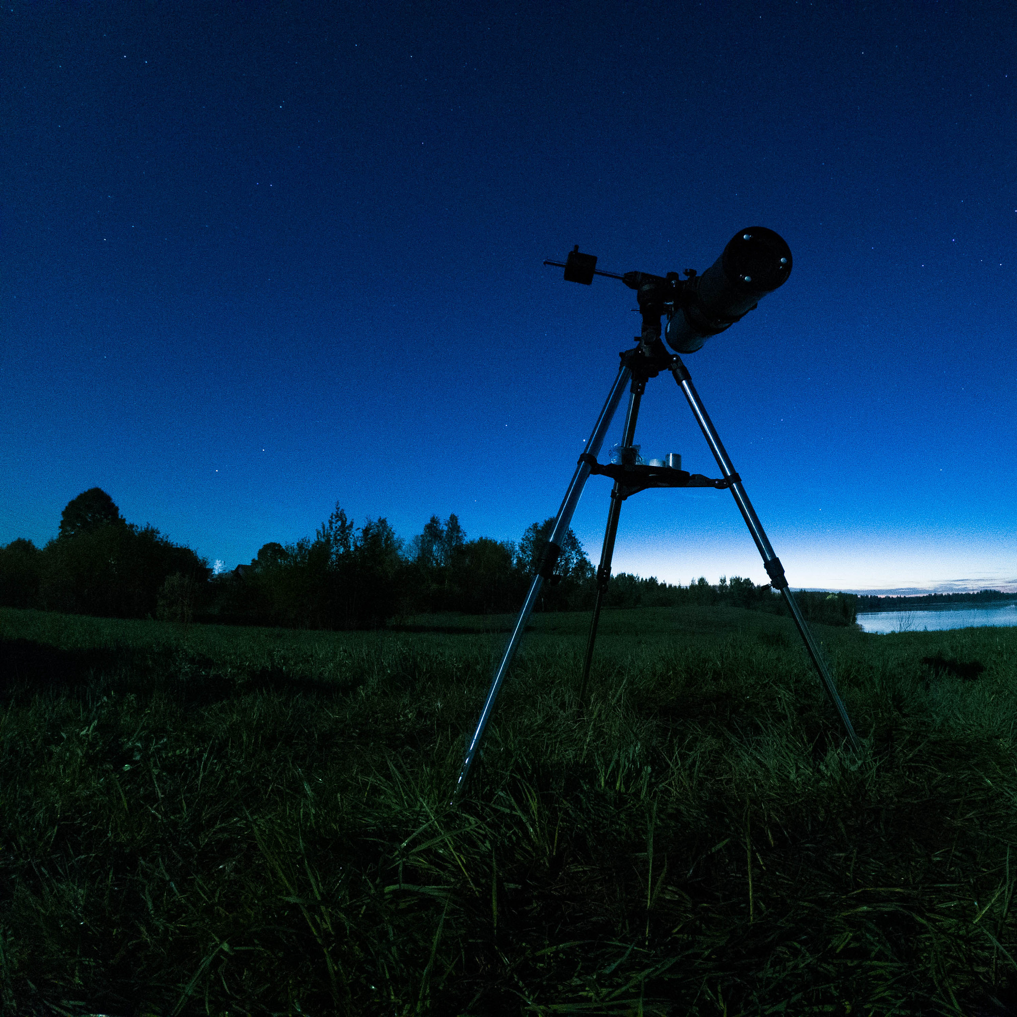 telescope on a tripod at night in nature against the backdrop of