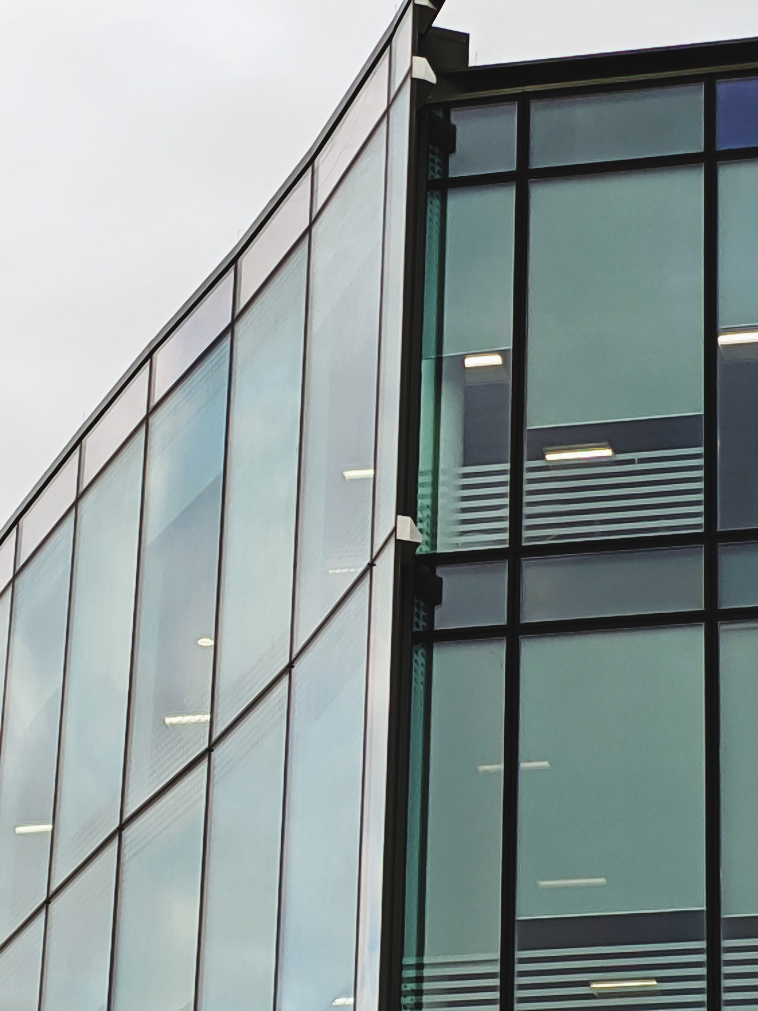 low angle view of glass building against sky