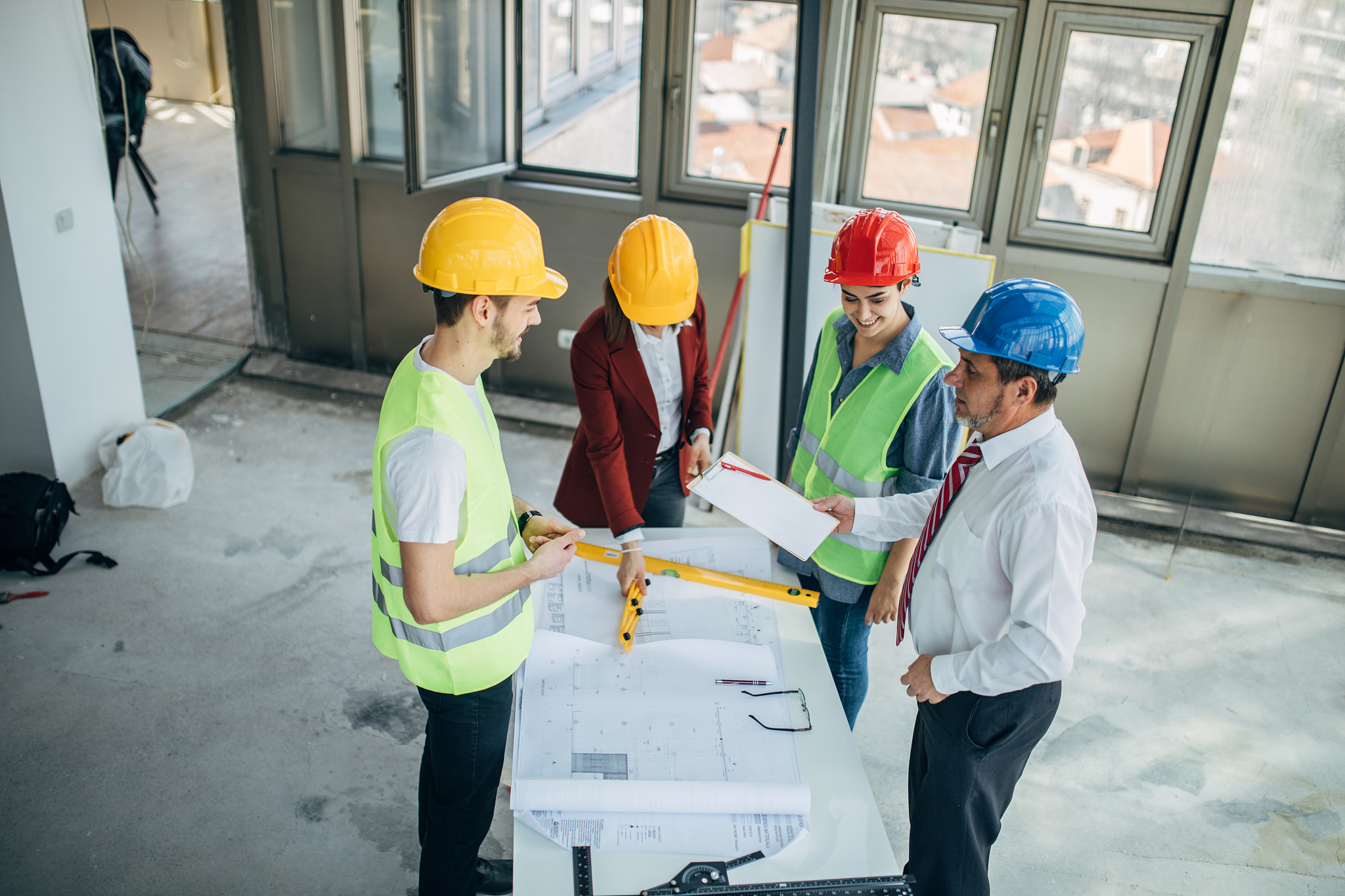 construction workers and architects working on construction site