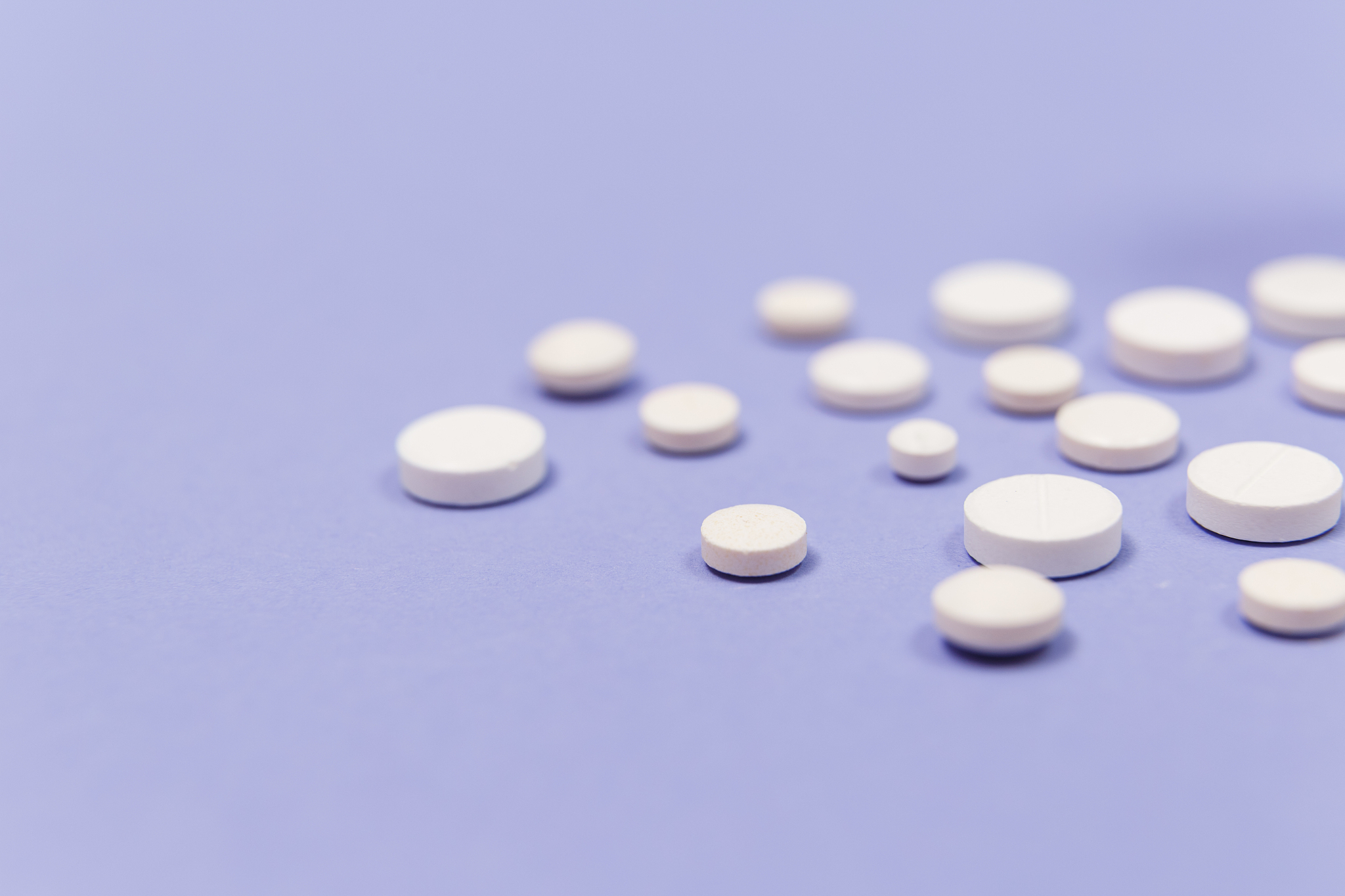 white pill on a purple background with copy space. antibiotics d