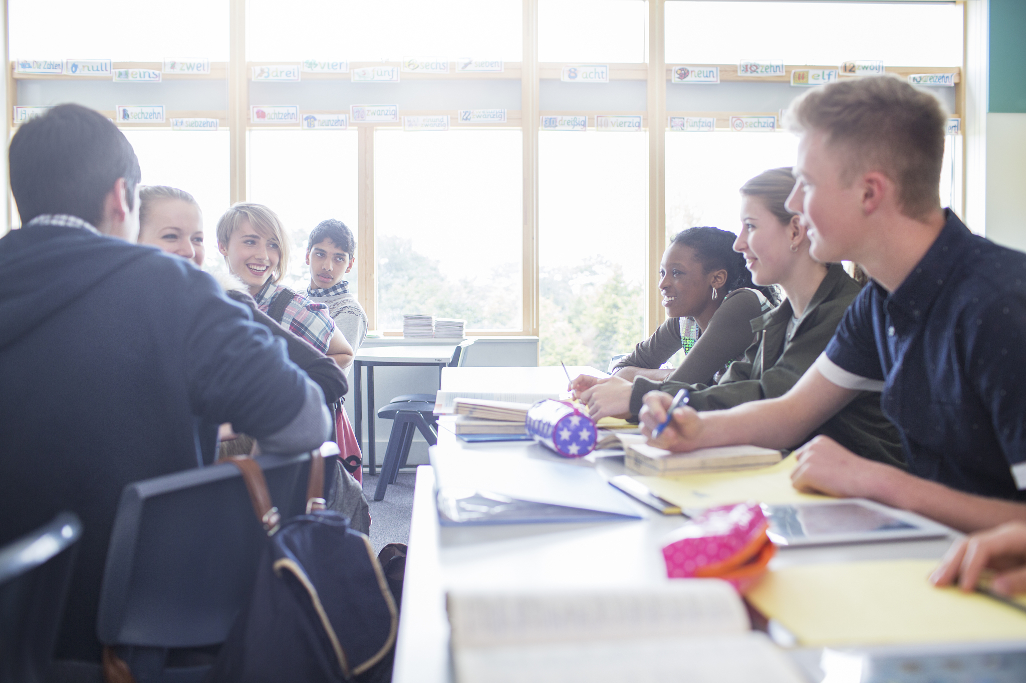 students talking in classroom during lesson