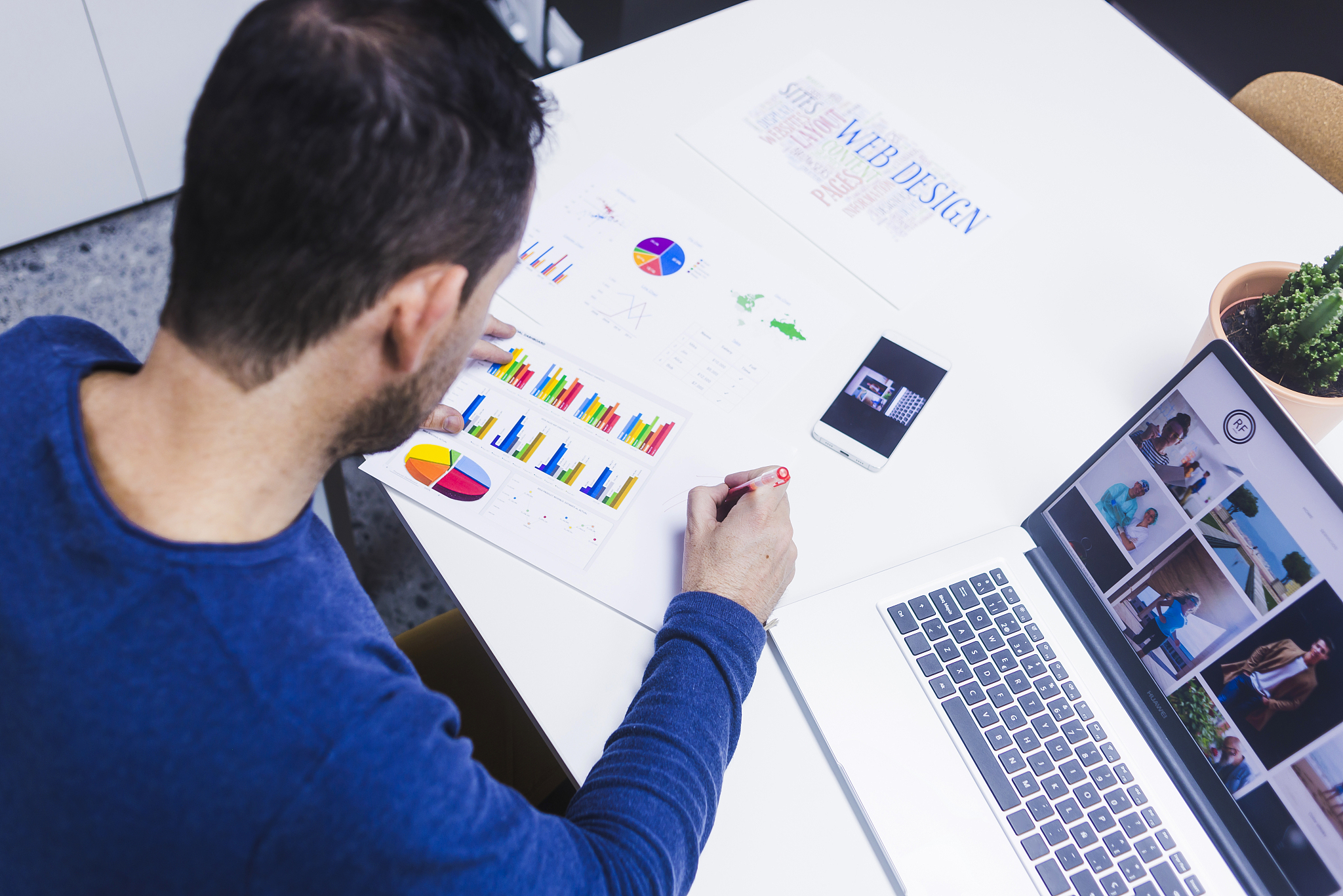 man working on documents at desk in office