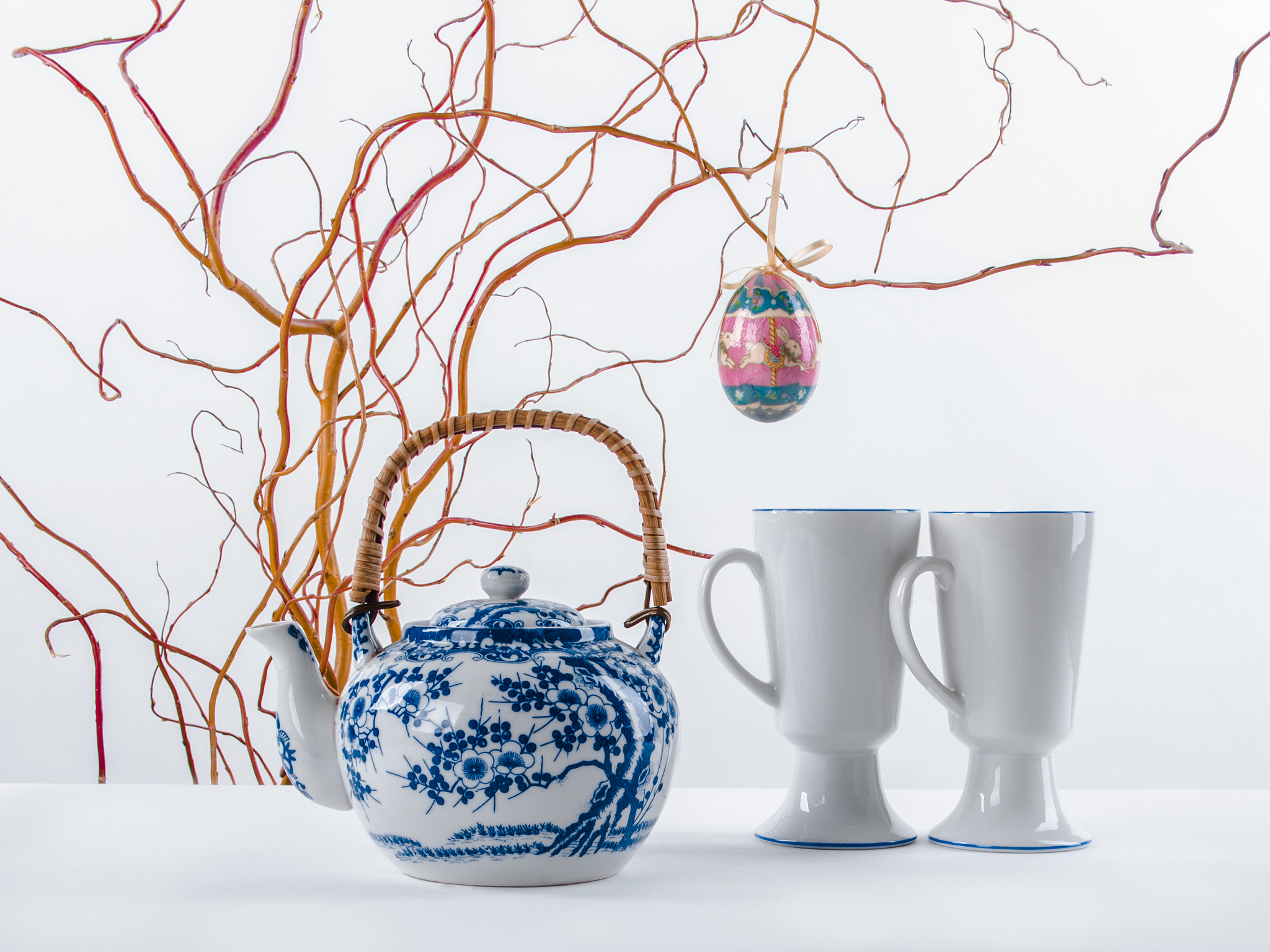 elegant easter still life with decorative egg, teapot and twoo c