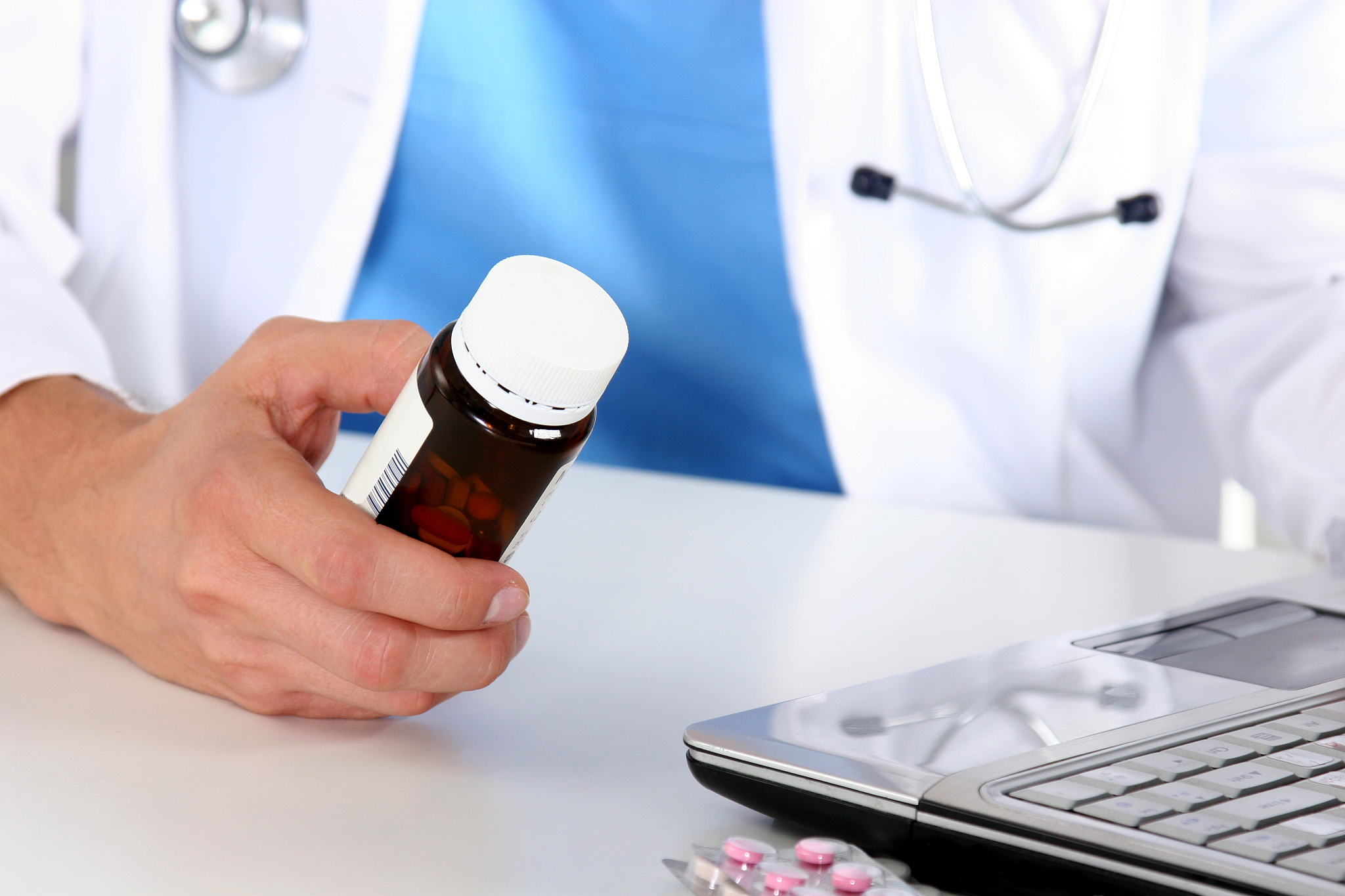 hand of doctors holding many different pills