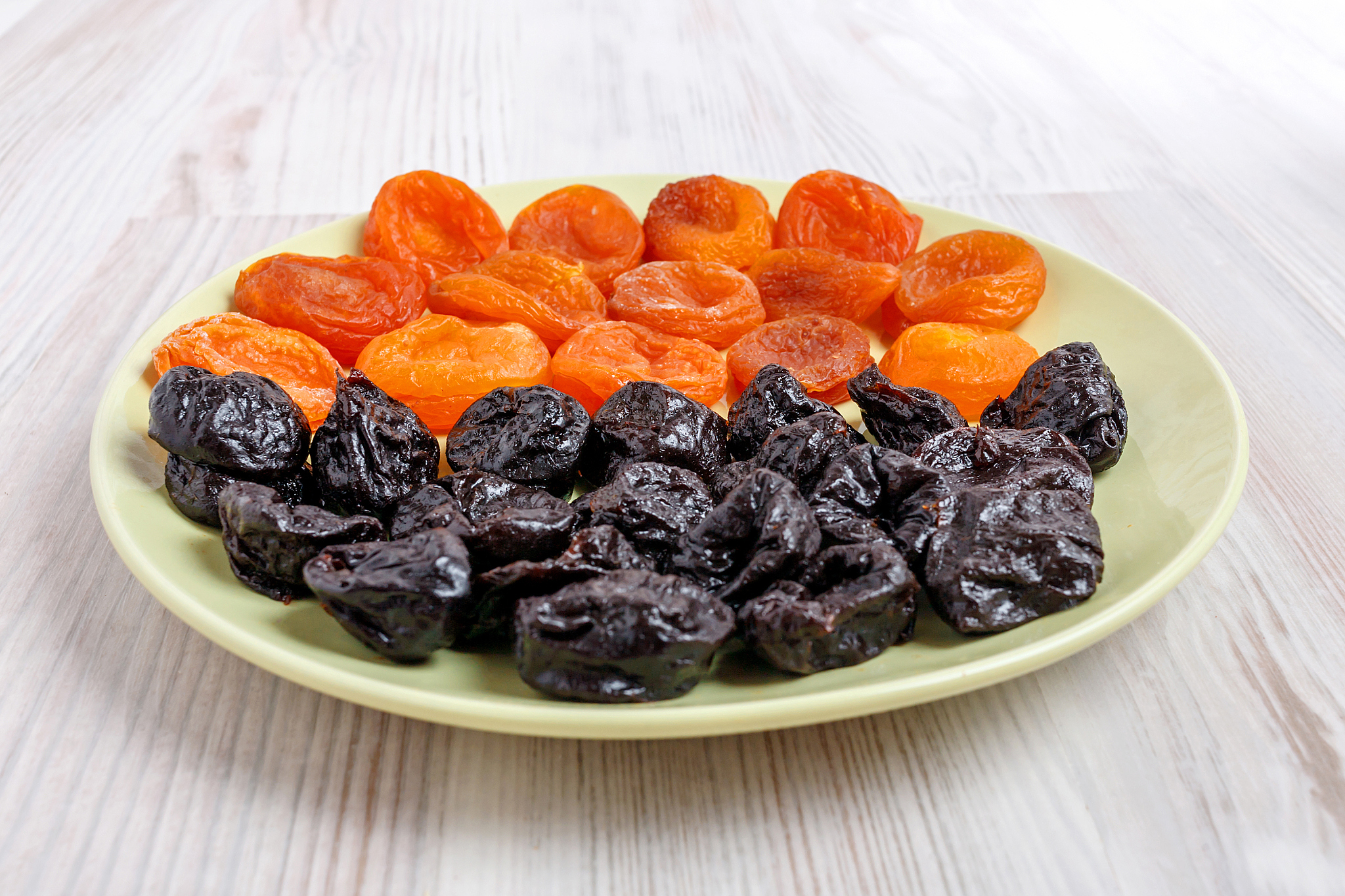 plate of dried apricots and prunes.