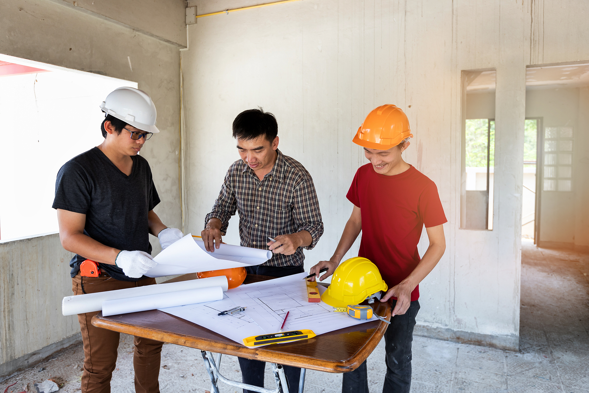 engineer and architect discussing with foreman about project in 