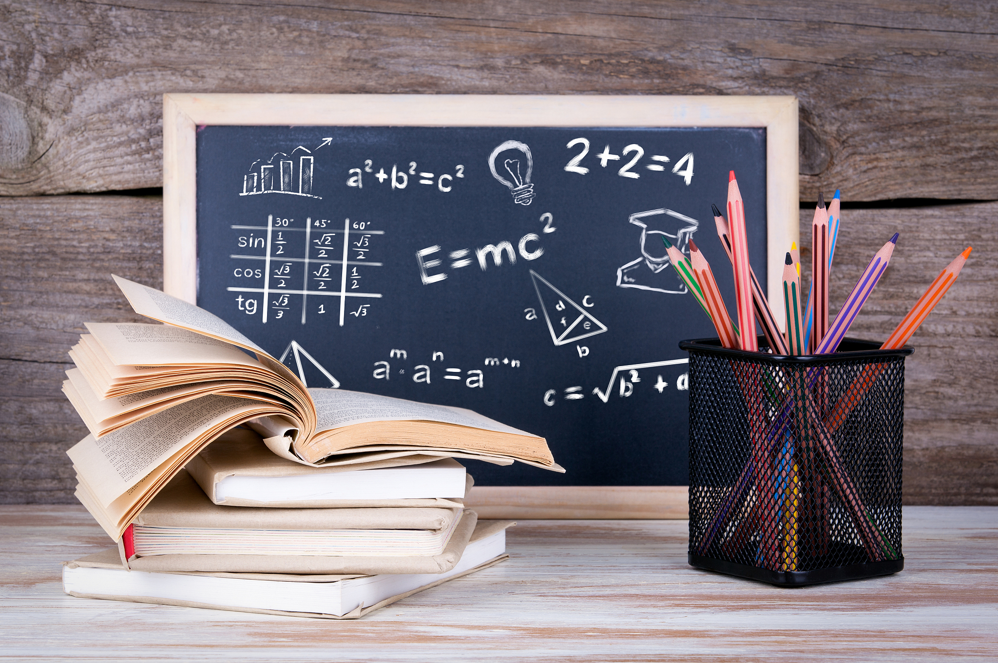 math formulas, education and knowledge concept. stack of books a