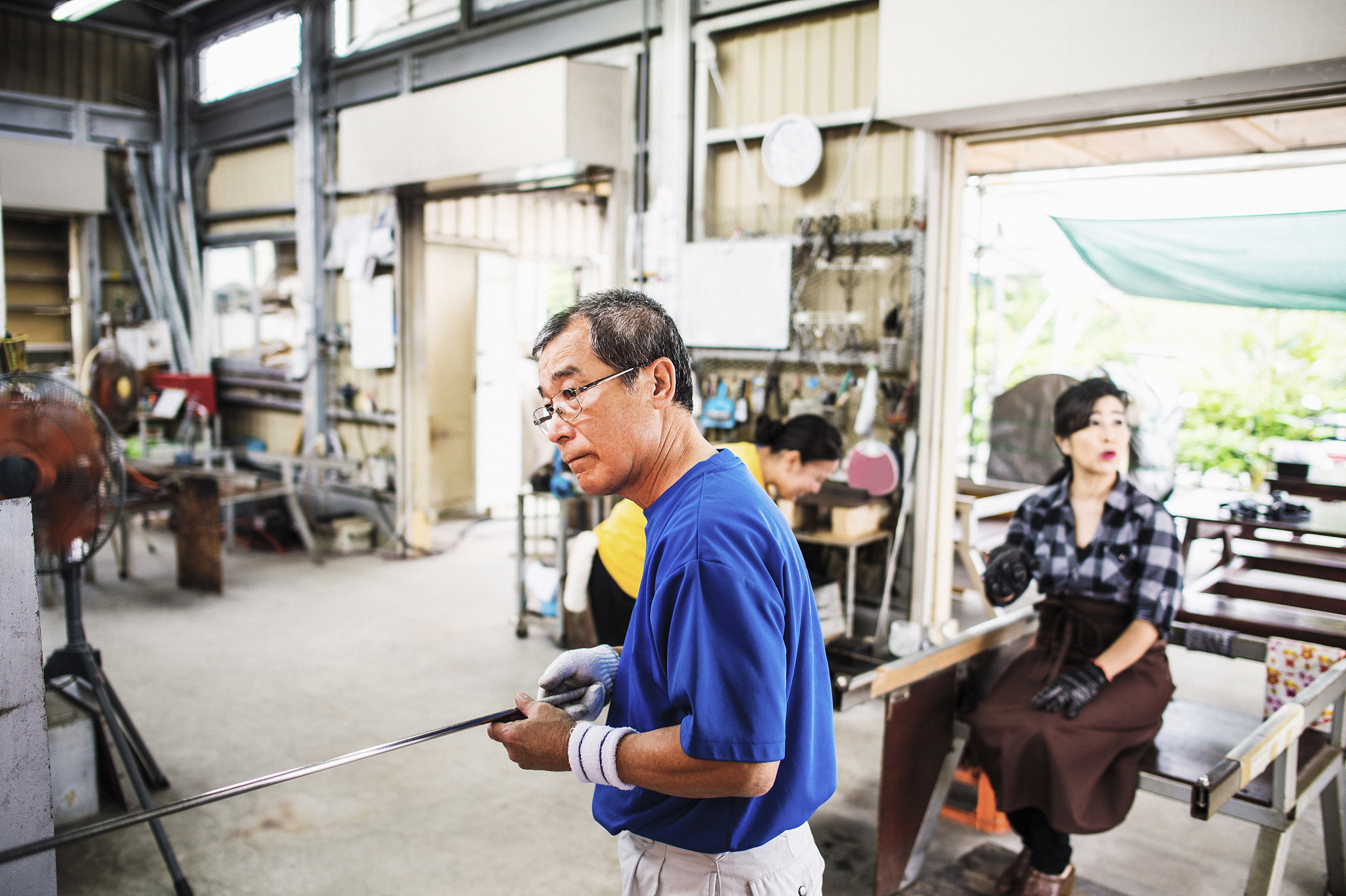 senior adult man working in glass factory