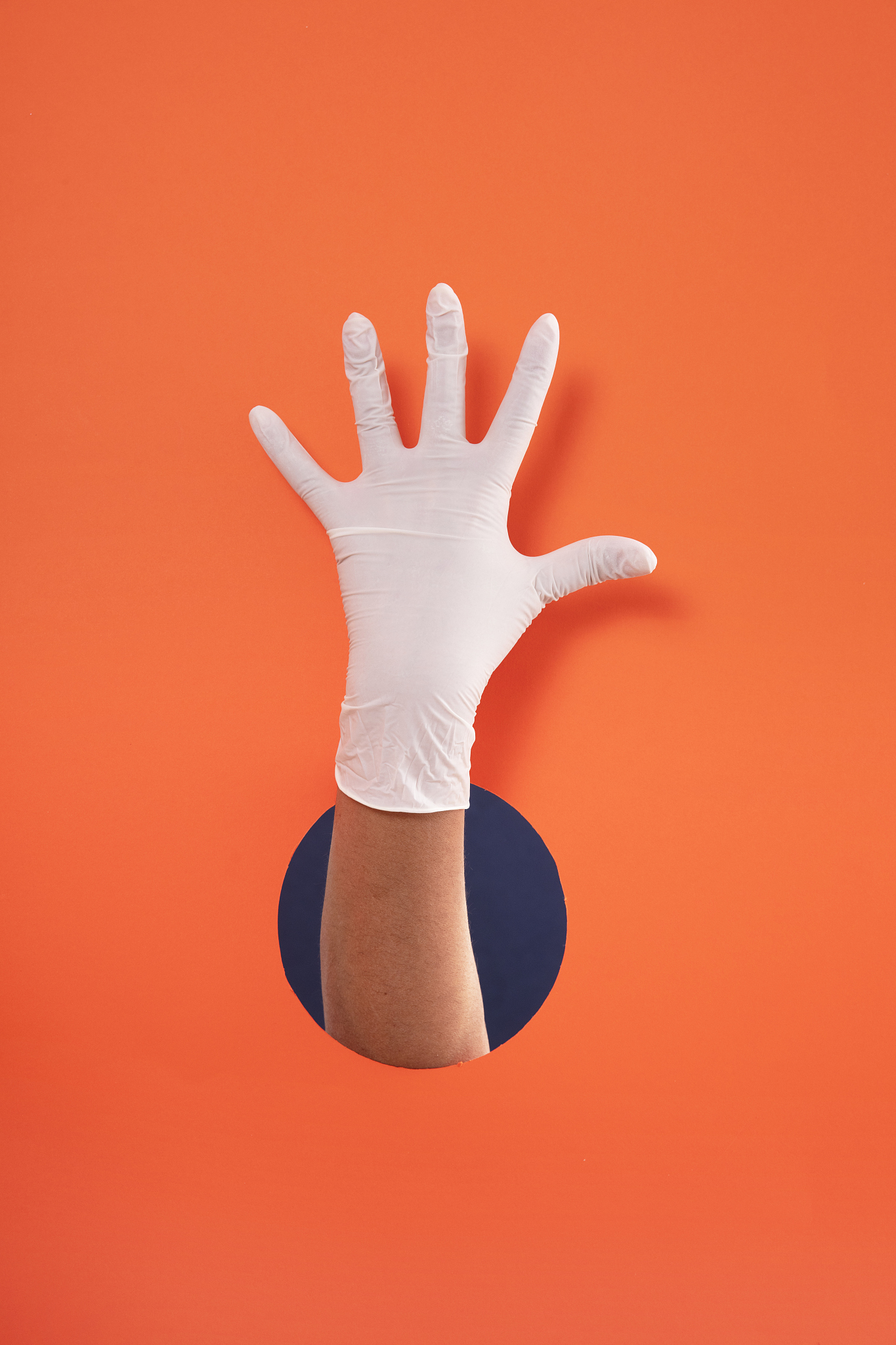 doctor hand with white medical glove showing number five on oran