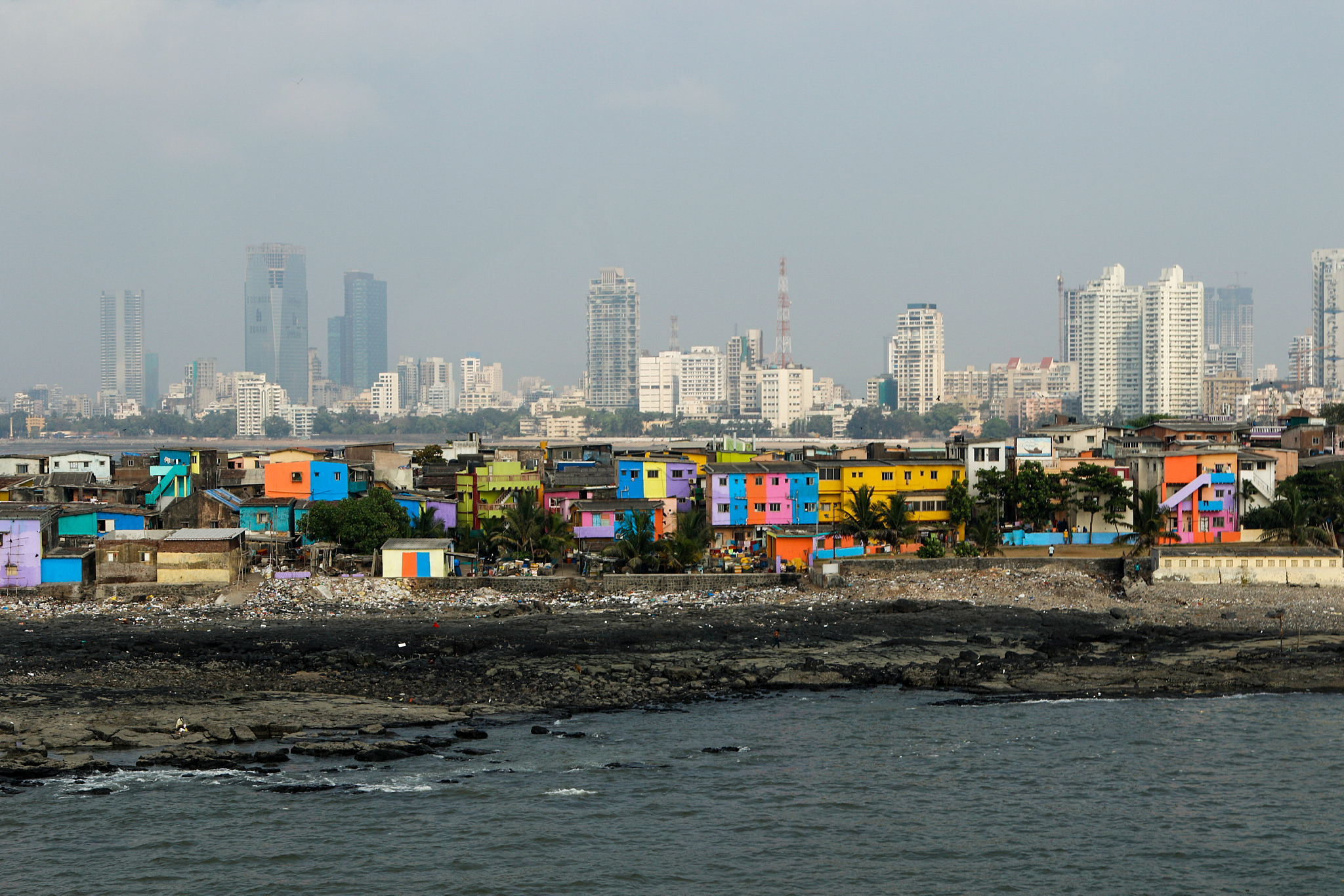 buildings by sea against sky in city