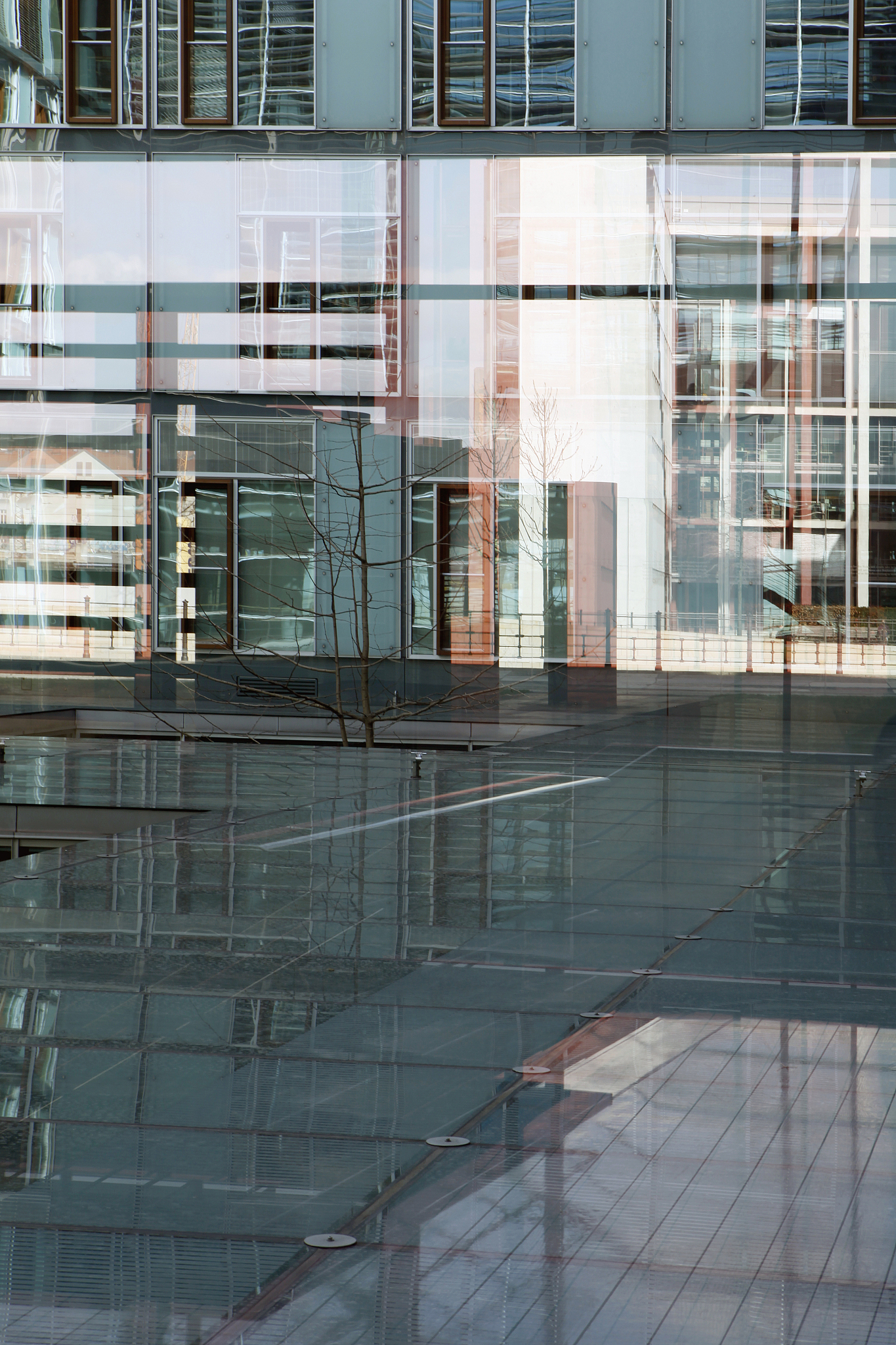 mixed reflections on glass floor and walls of jakob kaiser haus