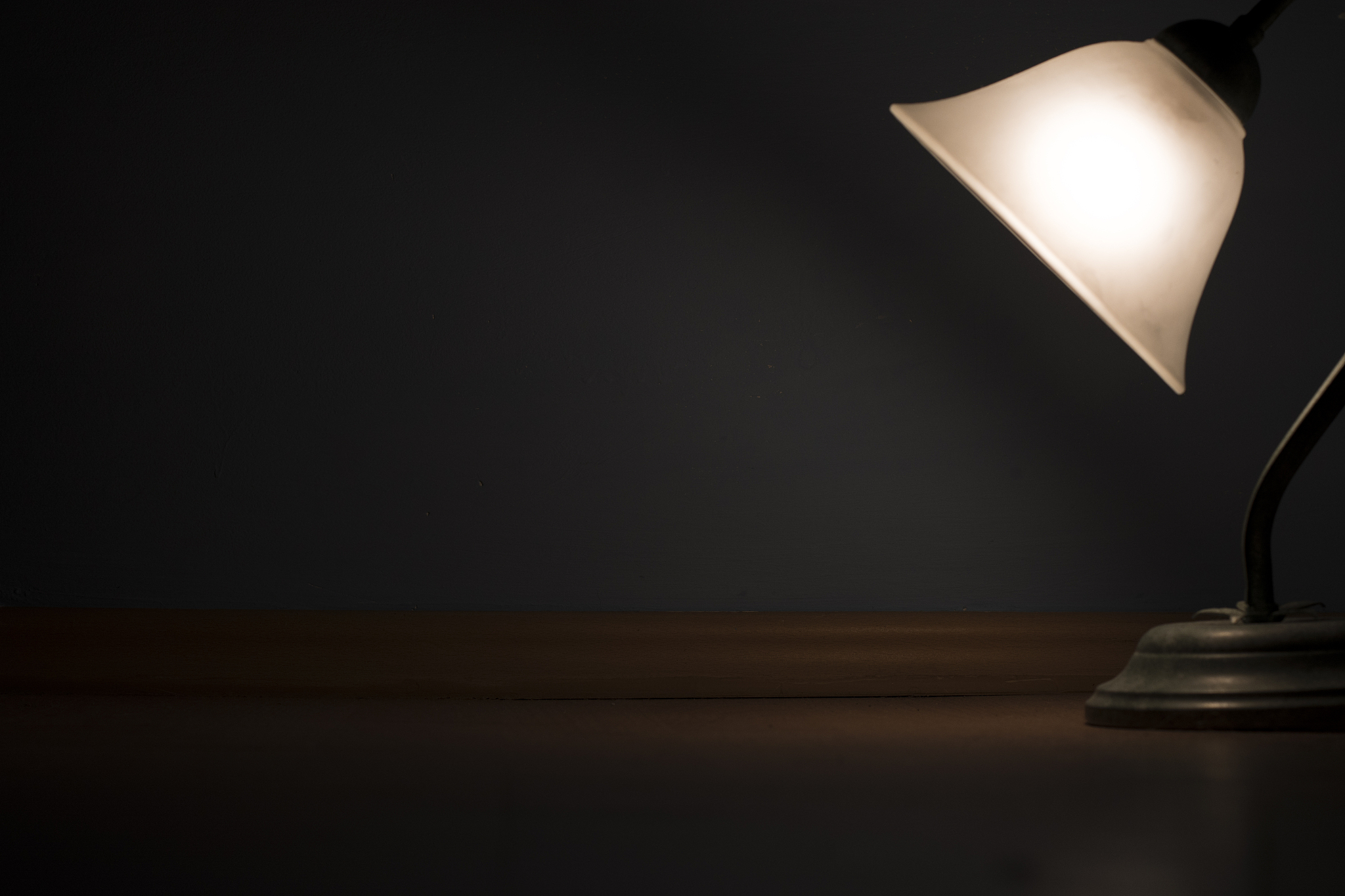 old lamp with glowing light on wooden floor