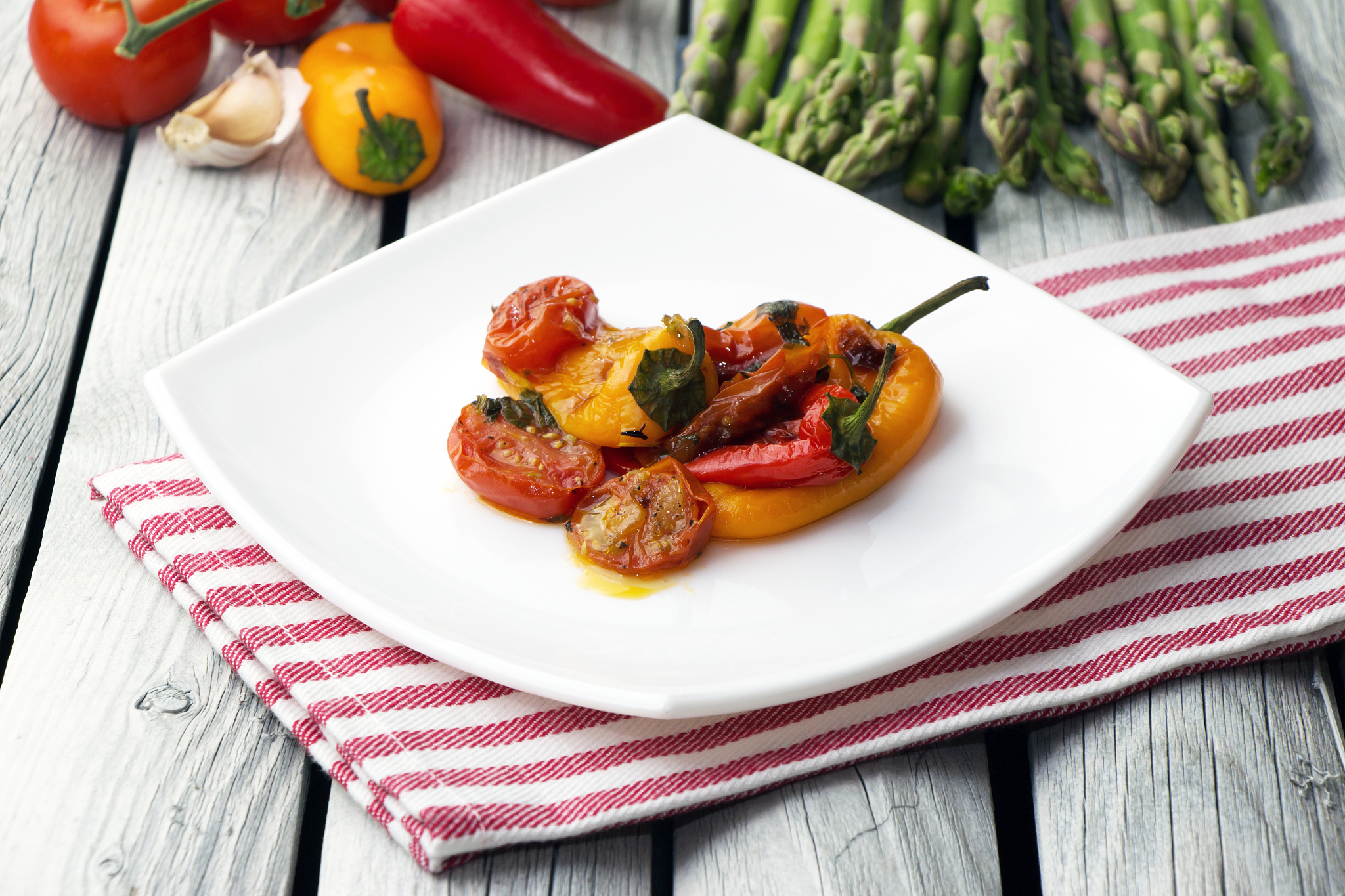 roasted bell peppers with tomato sauce on the white rectangular 