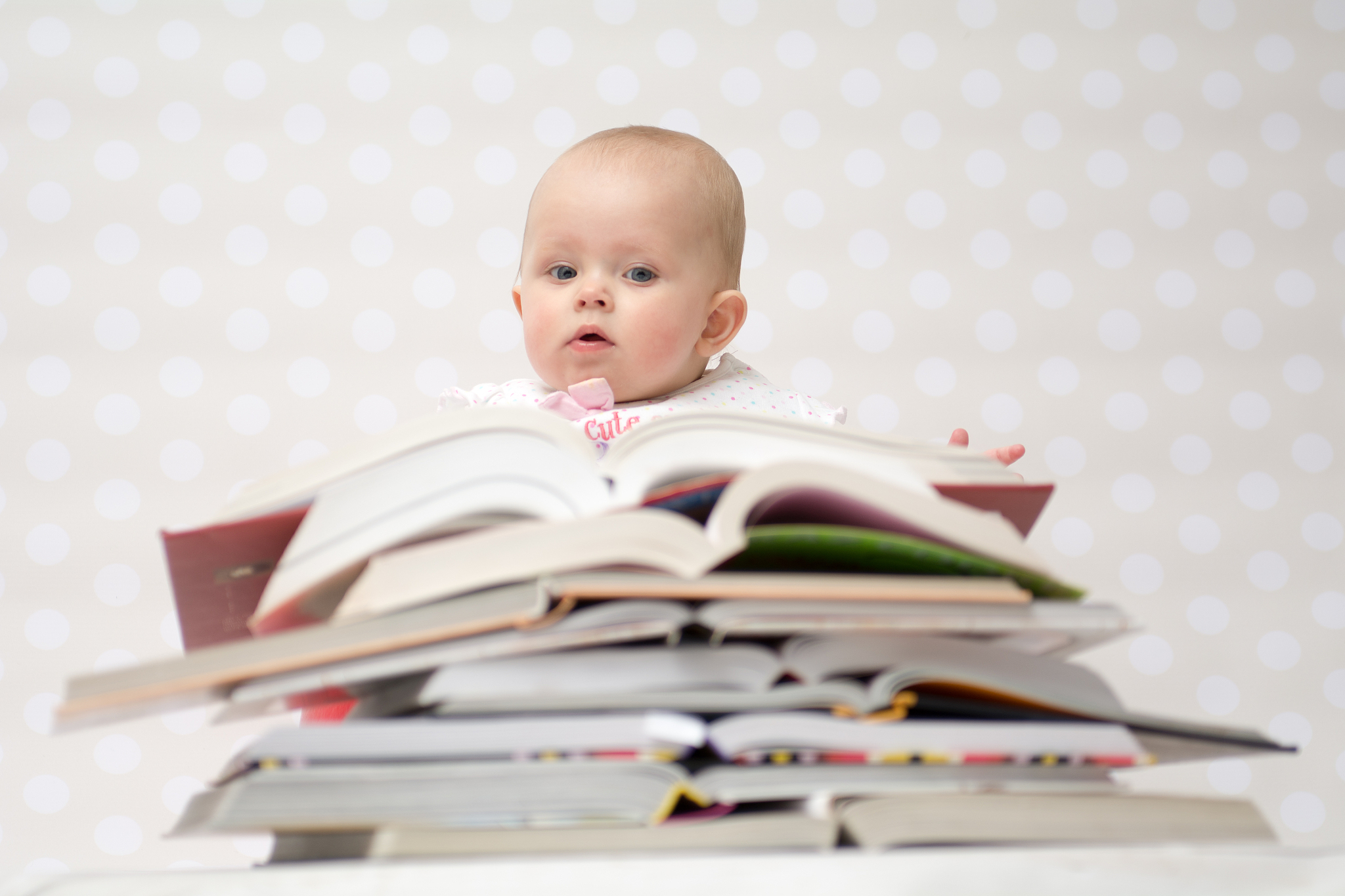 baby with pile of books