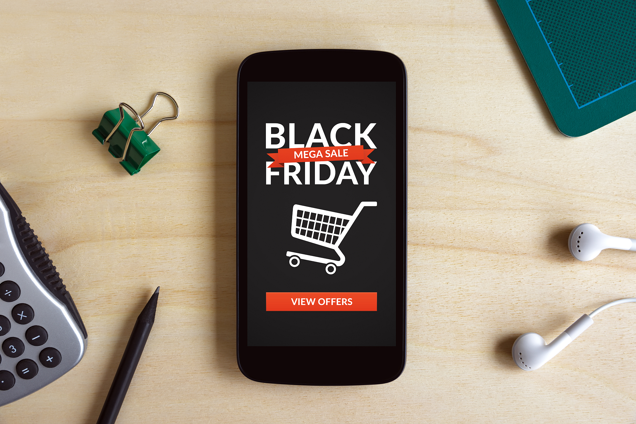 black friday concept on smart phone screen on wooden desk