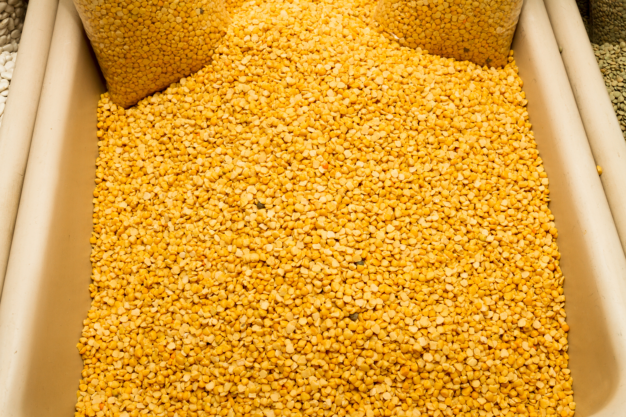 dried yellow lentils on a market stand