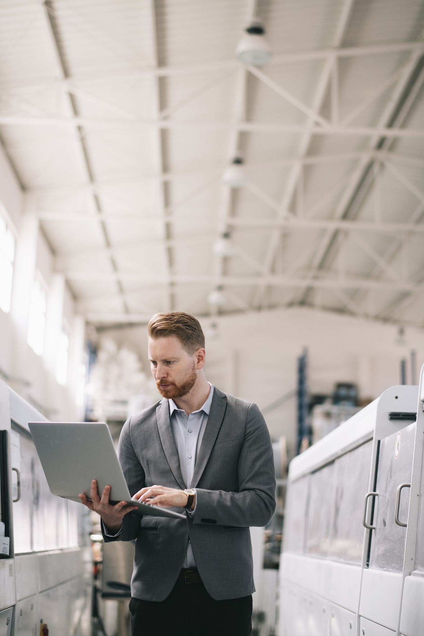 business man checking quality on laptop in factory