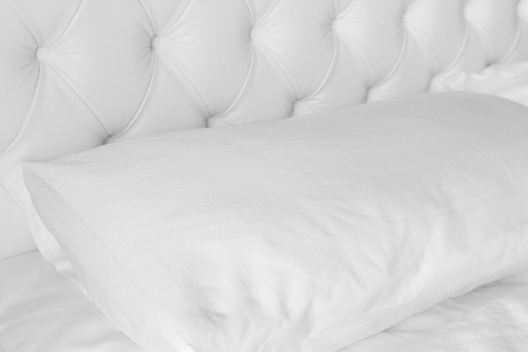 white pillow on white luxury bed.