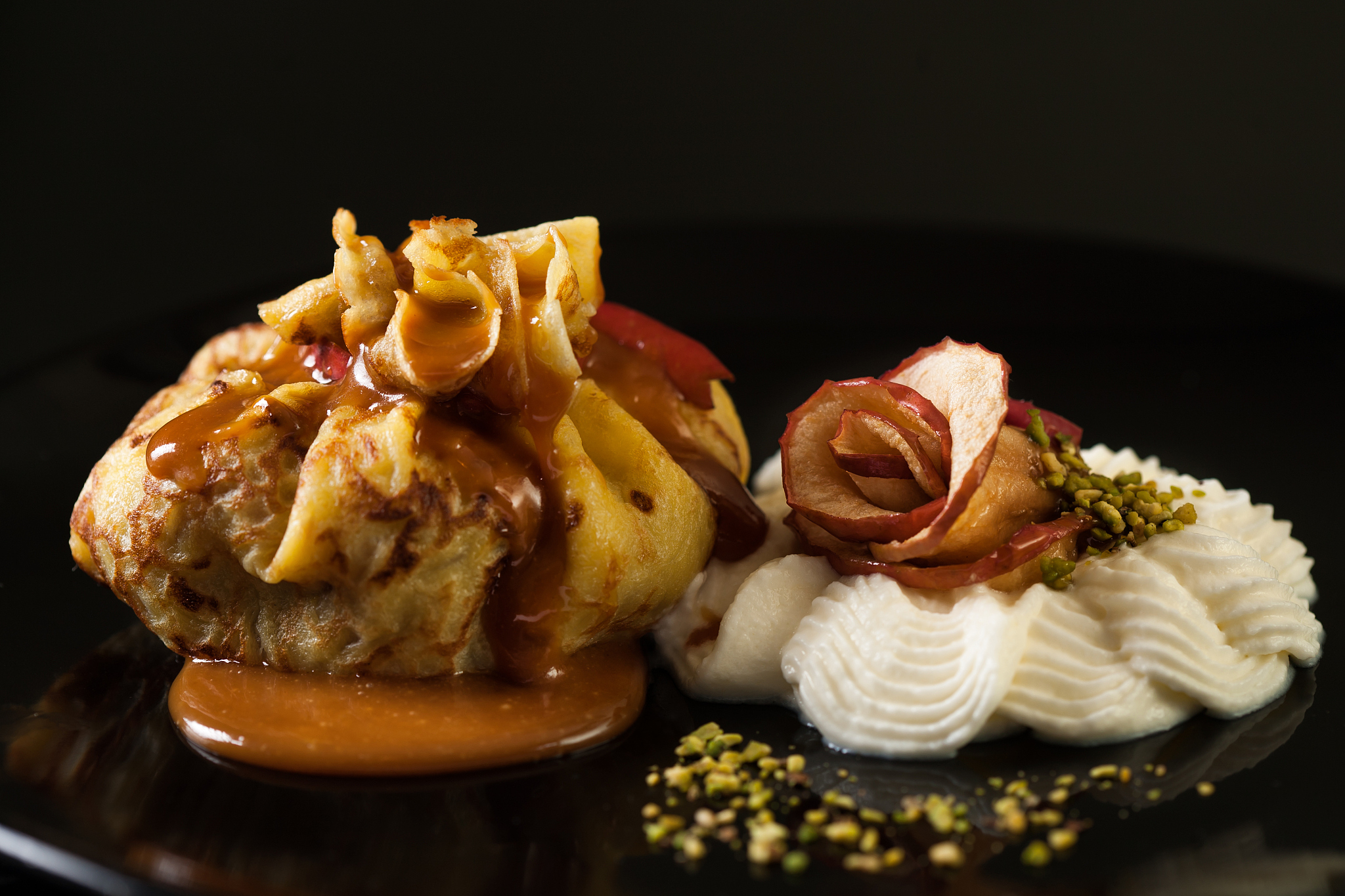 pancake filled with apple, served with cream and caramel.